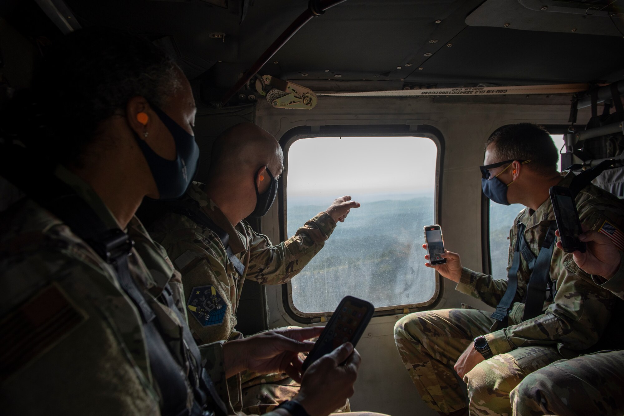 FORT CARSON, Colo. – U.S. Space Force Col. Shay Warakomski, Peterson-Schriever Garrison commander, and U.S. Air Force Col. Erica Farmer-Hill, 50th Mission Support Group commander and P-S GAR vice commander, ride in a Sikorsky UH-60 Black Hawk to Camp Red Devil on Fort Carson, Colorado to visit with Airmen participating in the chemical, biological, radiological and nuclear defense exercise, Aug. 18, 2021. Airmen and Guardians participating in the exercise were trained and tested on the concepts of CBRN defense in order to survive CBRN related attacks. (U.S. Space Force photo by Airman 1st Class Kaitlin Castillo)