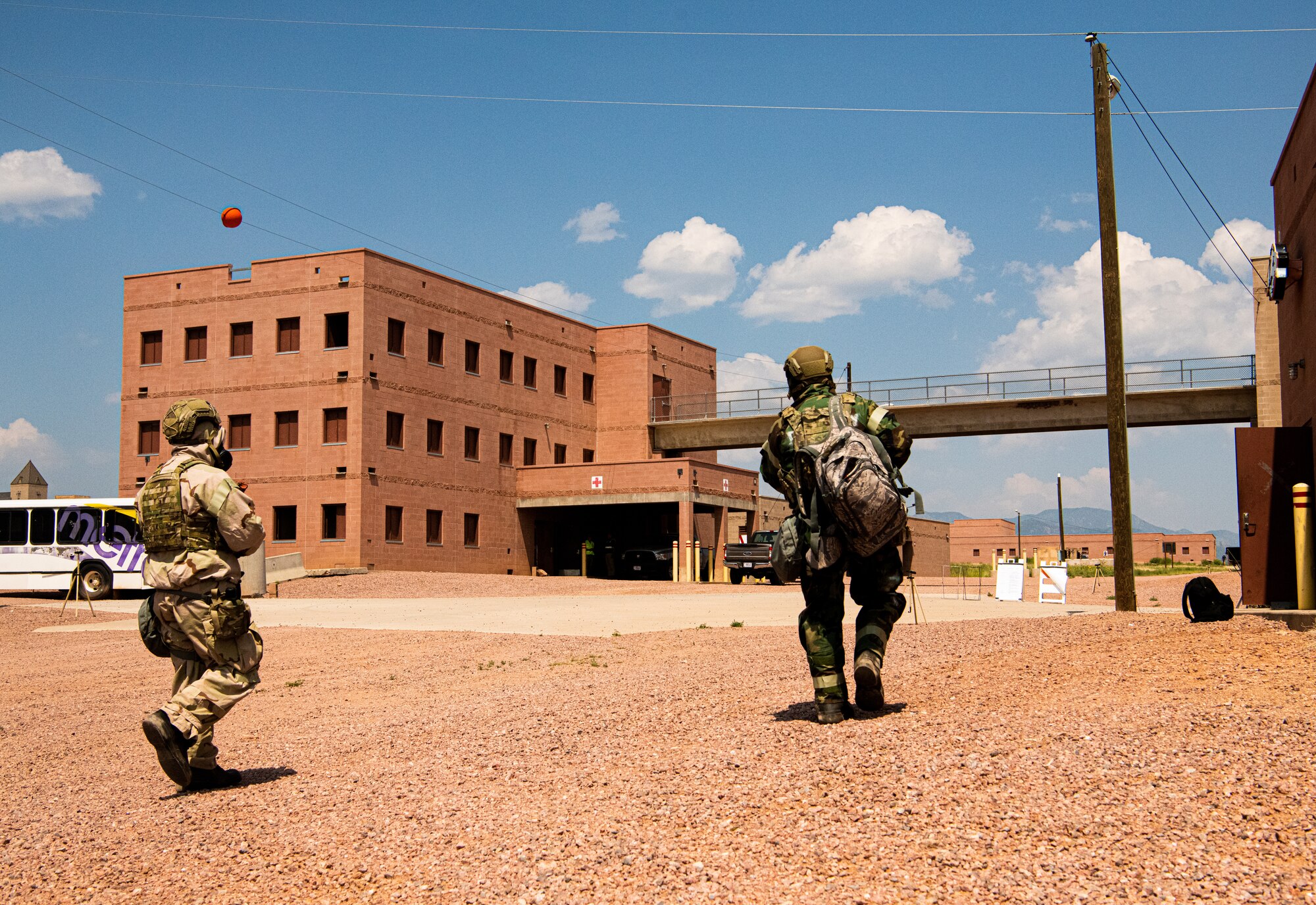 Participants from the Peterson-Schriever Garrison conduct a site survey in Mission Oriented Protective Posture 4 gear during a chemical, biological, radiological, and nuclear exercise at Fort Carson, Colorado, Aug. 18 2021.  MOPP 4 is the highest MOPP level, intended to increase personal protection against chemical, biological, radiological, nuclear, and explosive threats. (U.S. Space Force photo by Airman 1st Class Joshua Fontenot)