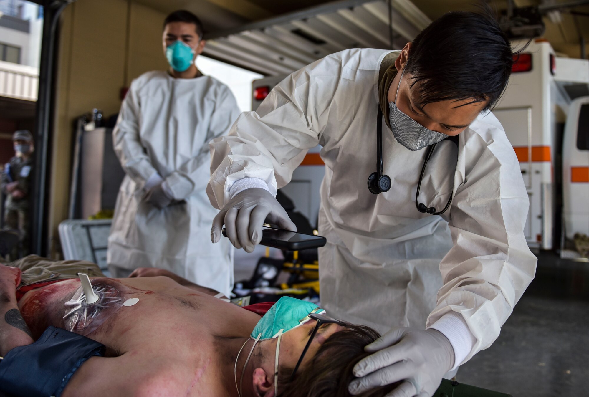 U.S. Air Force Capt. Jacob Thomas, 92nd Operational Medical Readiness Squadron physician, treats a simulated patient during Exercise Ready Eagle at Fairchild Air Force Base, Washington, Aug. 27, 2021.