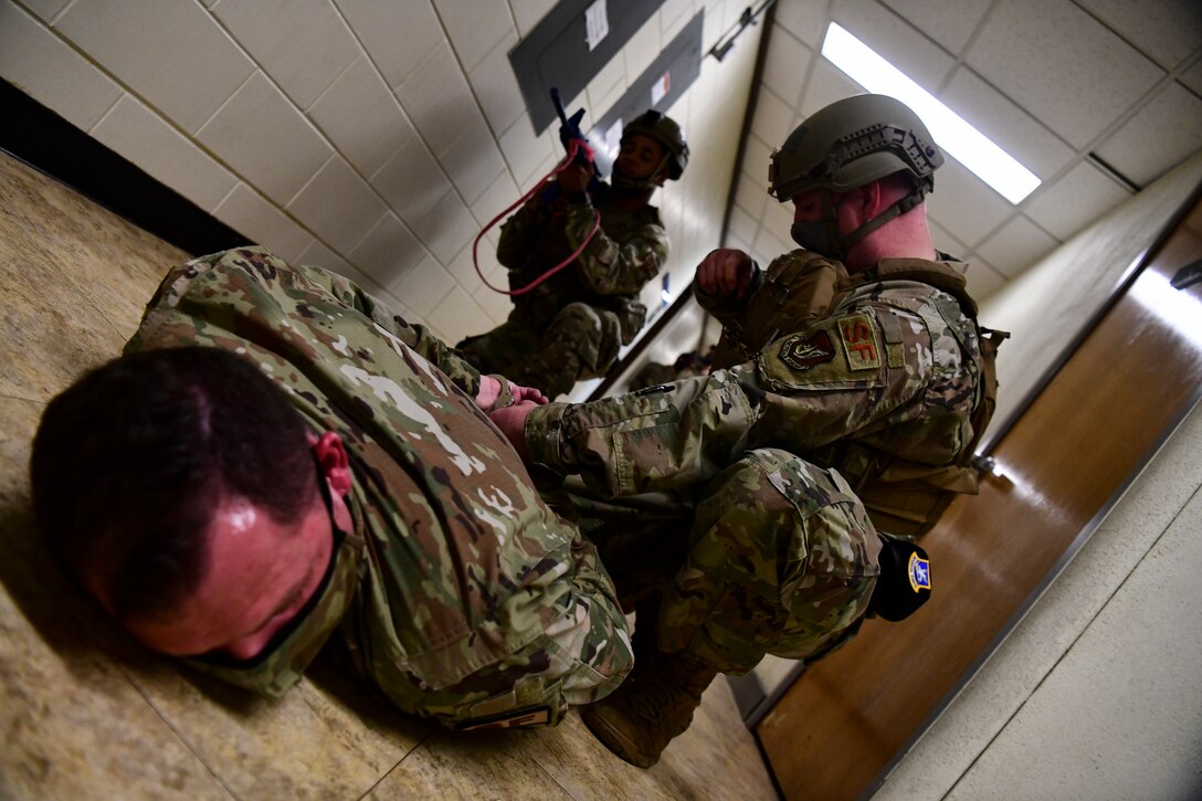 An Airmen detains a suspect during training.