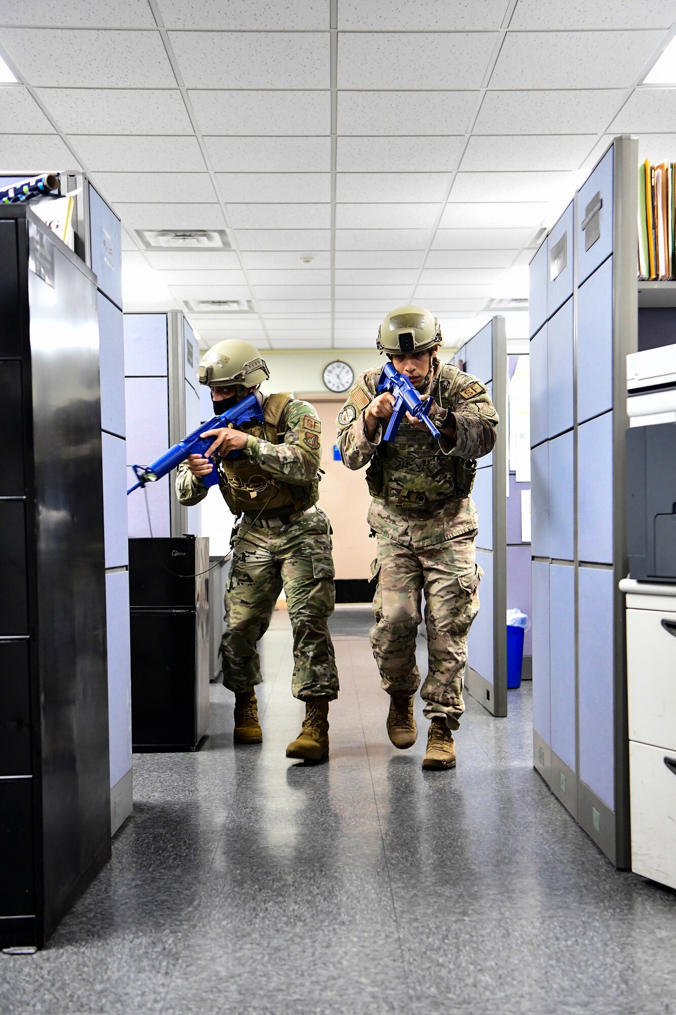 Airmen clear out a building during training.