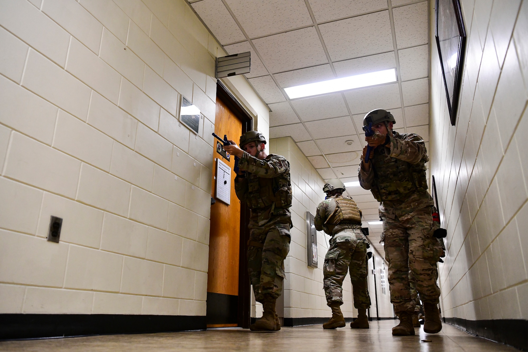 Airmen search a building during training.