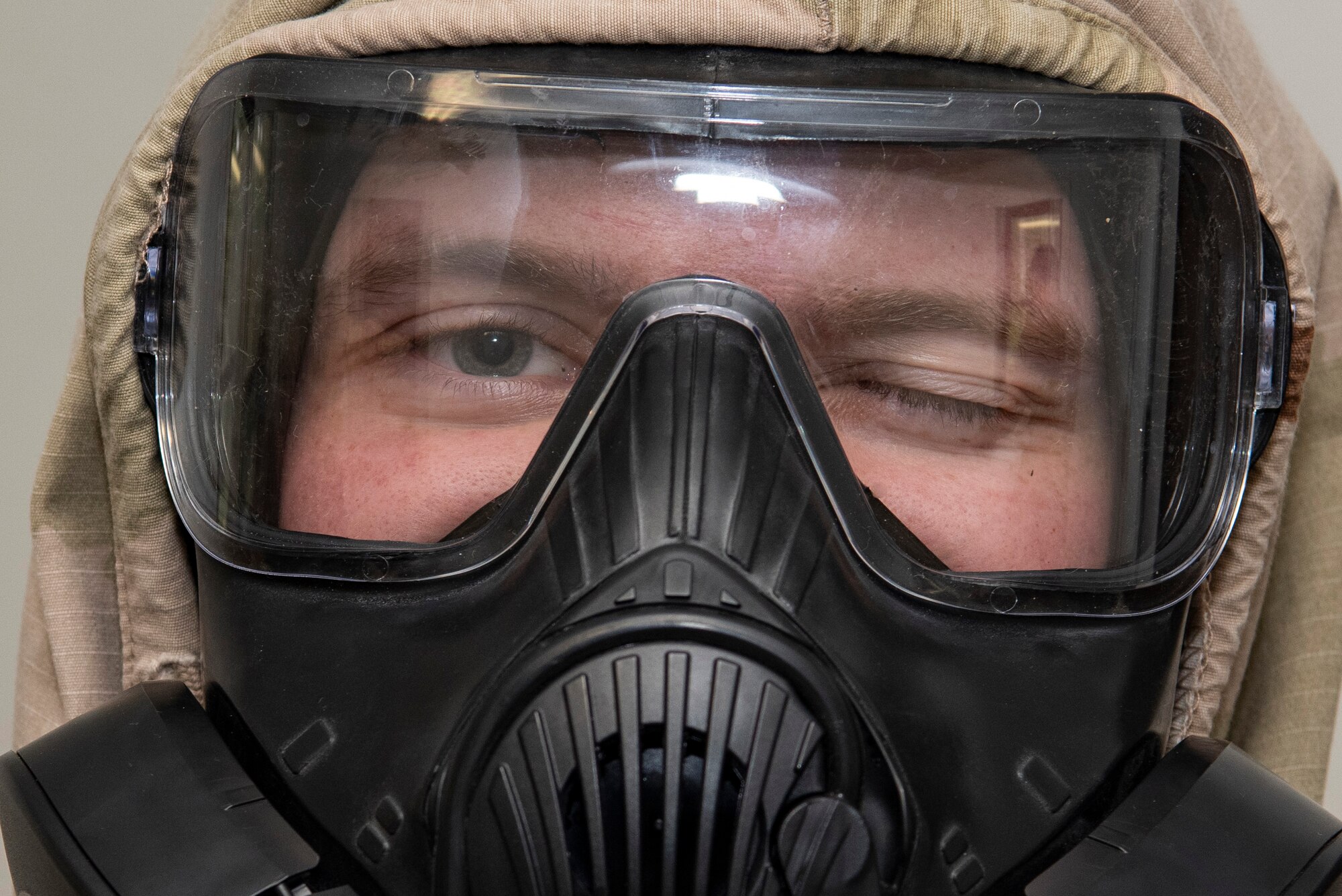 A U.S. Army paratrooper assigned to the 1st Battalion, 501st Parachute Infantry Regiment, 4th Infantry Brigade Combat Team (Airborne), 25th Infantry Division, U.S. Army Alaska, completes the Chemical, Biological, Radiological and Nuclear defense station at Joint Base Elmendorf-Richardson, Alaska, Aug. 26, 2021. Soldiers assigned to the 4/25th IBCT completed various stations for a best squad competition. (U.S. Air Force photo by Senior Airman Emily Farnsworth)