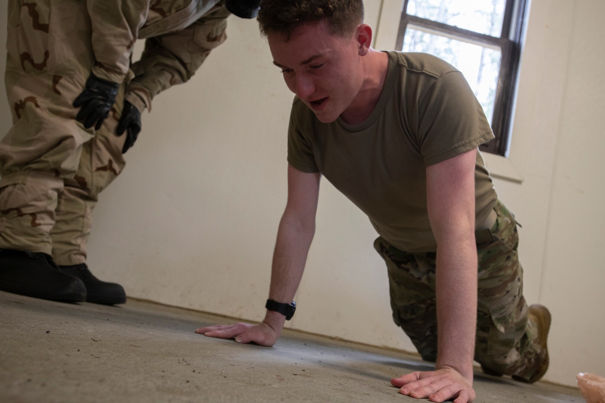 U.S. Army Pfc. Michael Gallagher, a combat medic assigned to Headquarters and Headquarters Troop, 1st Squadron (Airborne), 40th Cavalry Regiment, 4th Infantry Brigade Combat Team (Airborne), 25th Infantry Division, U.S. Army Alaska, does pushups while exposed to non-lethal o-Chlorobenzylidene malononitrile (CS) gas while setting up Chemical, Biological, Radiological and Nuclear defense training at Joint Base Elmendorf-Richardson, Alaska, Aug. 26, 2021. Gallagher was a medic at the CBRN defense station during the 4/25th IBCT best squad competition. (U.S. Air Force photo by Senior Airman Emily Farnsworth)