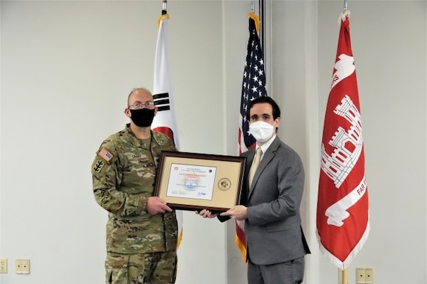 Dennis Headrick receives a certificate of recognition from Far East District Commander, Col. Christopher Crary, during graduation from the U.S. Army Corps of Engineers Leadership Development Program Level 2, July 19, 2021.