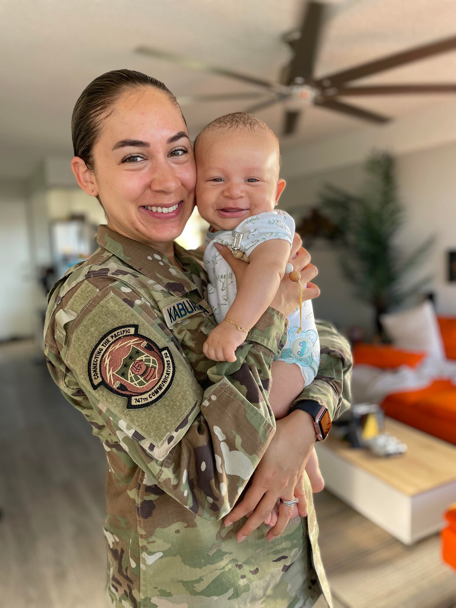 U.S. Space Force Capt. Charlene Kabuanseya, 747th Communications Squadron cyber defense flight commander, holds her 5-month-old child, Leo, in Honolulu, Hawaii, June 15, 2021. Kabuanseya recently reunited with Leo after a 45-day temporary duty travel. As a new nursing mother, she continued to provide breast milk while gone and received reimbursement with her commander’s approval, making it one of the first instances for a service member in the Department of Defense. (Courtesy photo)