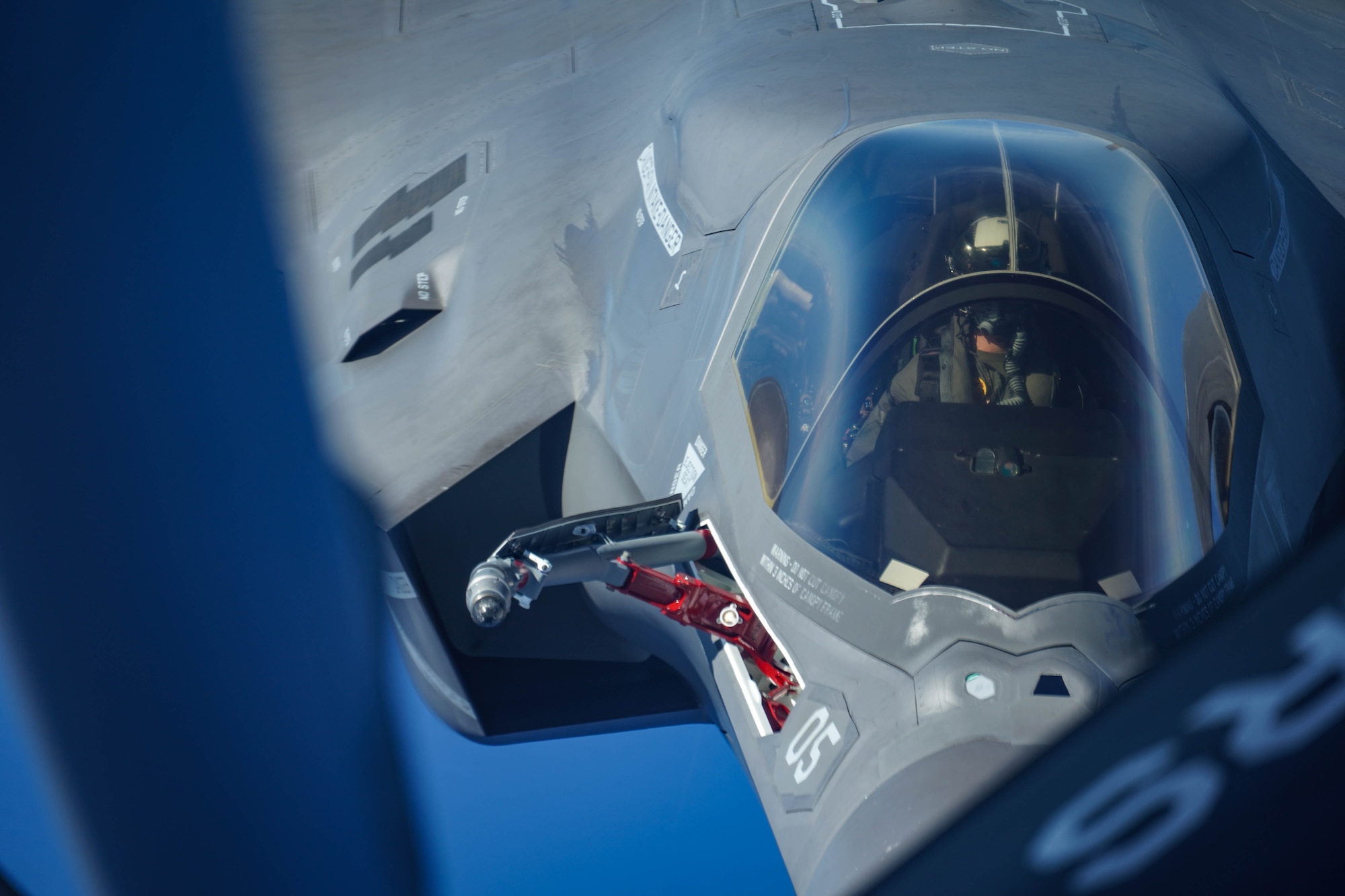 A U.S. Marine Attack Squadron 211 F-35B Lightning II, assigned to the United Kingdom Carrier Strike Group, refuels from a KC-135 Stratotanker, assigned to the 909th Air Refueling Squadron, Kadena Air Base, Japan during a Large Scale Global Exercise 21 mission over the western Pacific Ocean, Aug. 24, 2021. U.S. Joint Forces routinely operate across the region, maintaining the necessary readiness, flexibility and agility to respond to the changes in the operational environment.  (U.S. Air Force photo by Staff Sgt. Kyle Johnson)