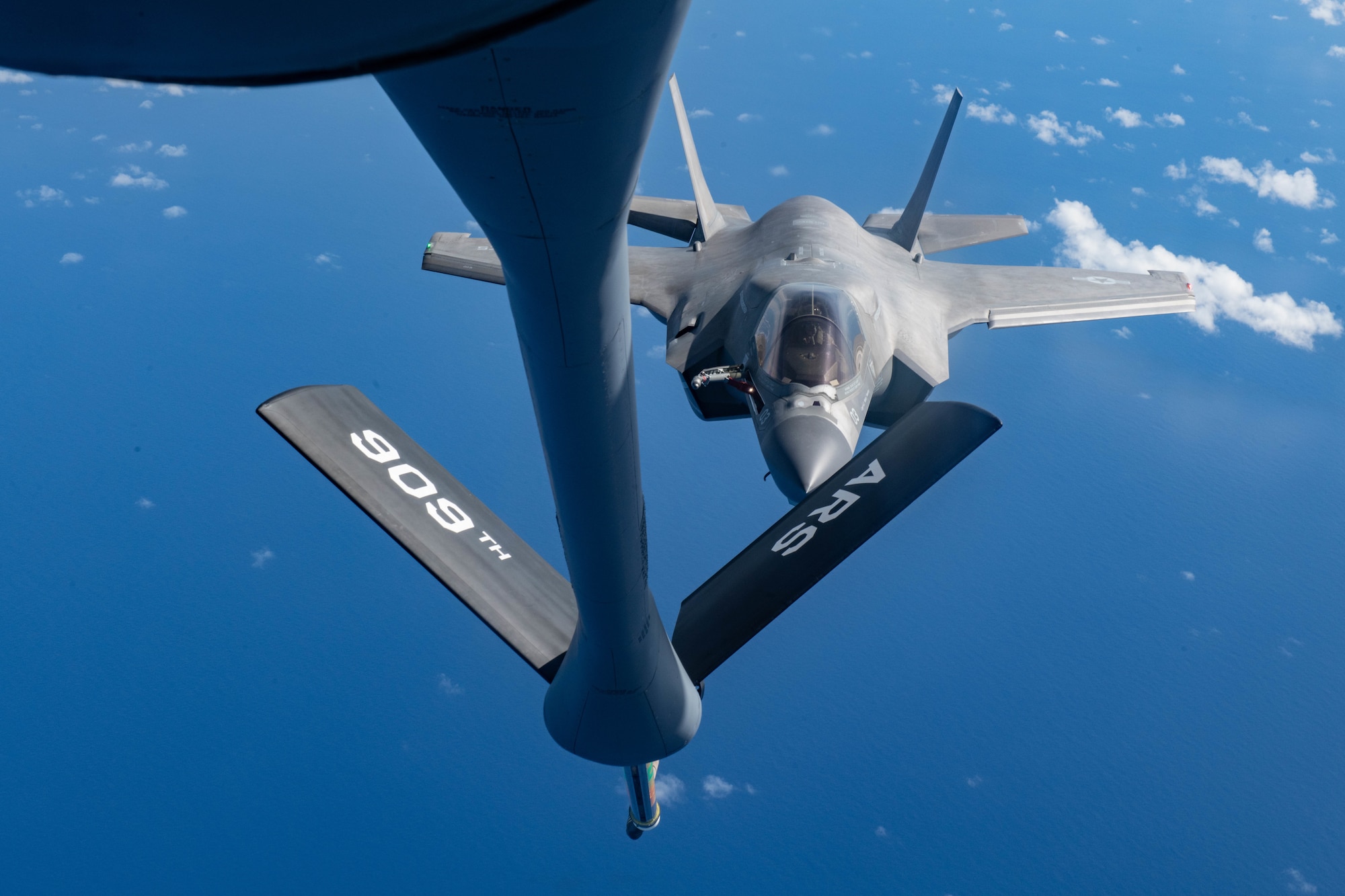 A U.S. Marine Attack Squadron 211 F-35B Lightning II, assigned to the United Kingdom Carrier Strike Group, refuels from a KC-135 Stratotanker, assigned to the 909th Air Refueling Squadron, Kadena Air Base, Japan during a Large Scale Global Exercise 21 mission over the western Pacific Ocean, Aug. 24, 2021. Kadena Air Base participated in LSGE 21, which is a Department of Defense exercise conducted by U.S. Indo-Pacific Command. (U.S. Air Force photo by Staff Sgt. Kyle Johnson)