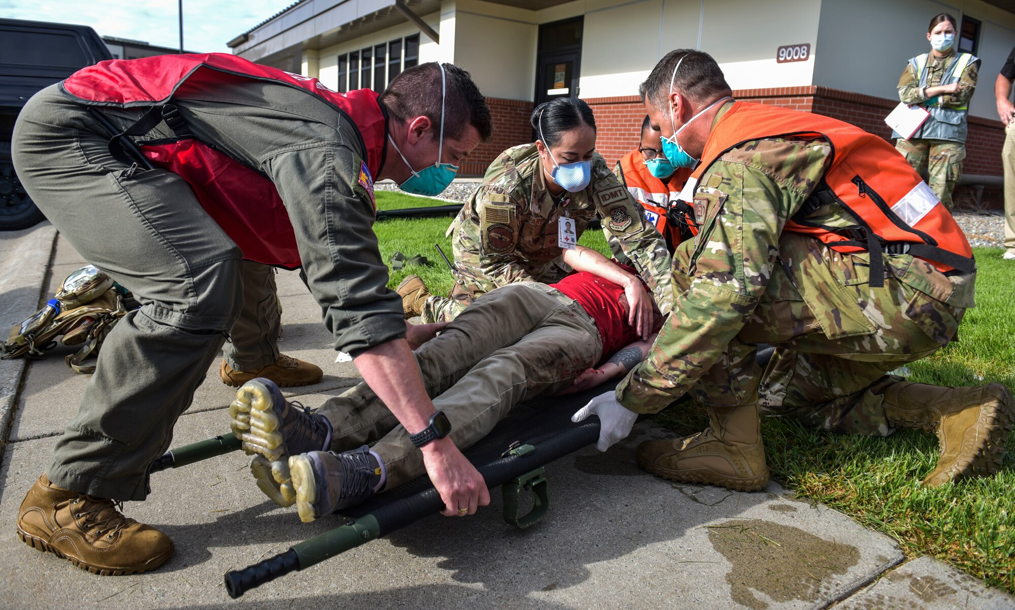 Members of the 92nd Medical Group place a simulated patient on a stretcher during Exercise Ready Eagle at Fairchild Air Force Base, Washington, Aug. 27, 2021.