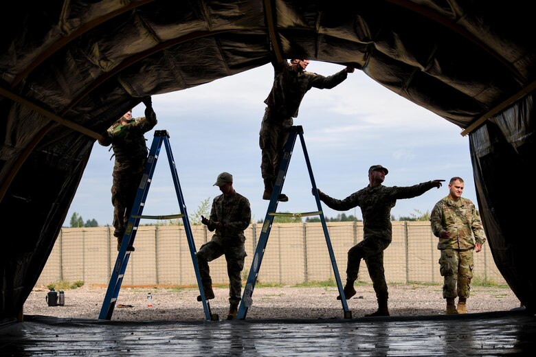 Two Mission Support Group Airman complete a team-building exercise during the readiness challenge at F.E. Warren Air Force Base, Wyoming, on August 19, 2021. The Readiness Challenge is a training tool for 90th Mission Support Group Airmen to practice deployment-related skills through team-building exercises. (U.S. Air Force photo by Airman 1st Class Faith Iris MacIlvaine)