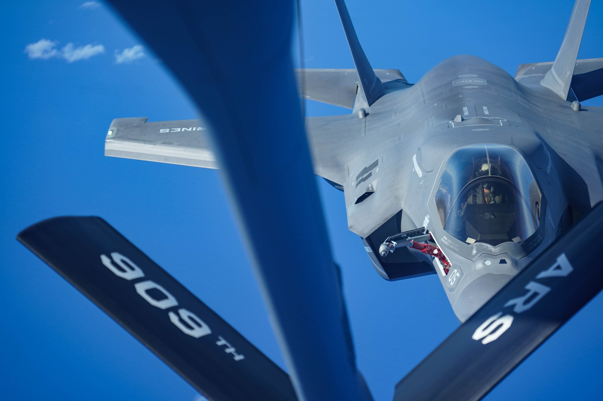A U.S. Marine Attack Squadron 211 F-35B Lightning II, assigned to the United Kingdom Carrier Strike Group, refuels from a KC-135 Stratotanker, assigned to the 909th Air Refueling Squadron, Kadena Air Base, Japan during a Large Scale Global Exercise 21 mission over the western Pacific Ocean, Aug. 24, 2021. U.S. Joint Forces routinely operate across the region, maintaining the necessary readiness, flexibility, and agility to respond to the changes in the operational environment. (U.S. Air Force photo by Staff Sgt. Kyle Johnson)