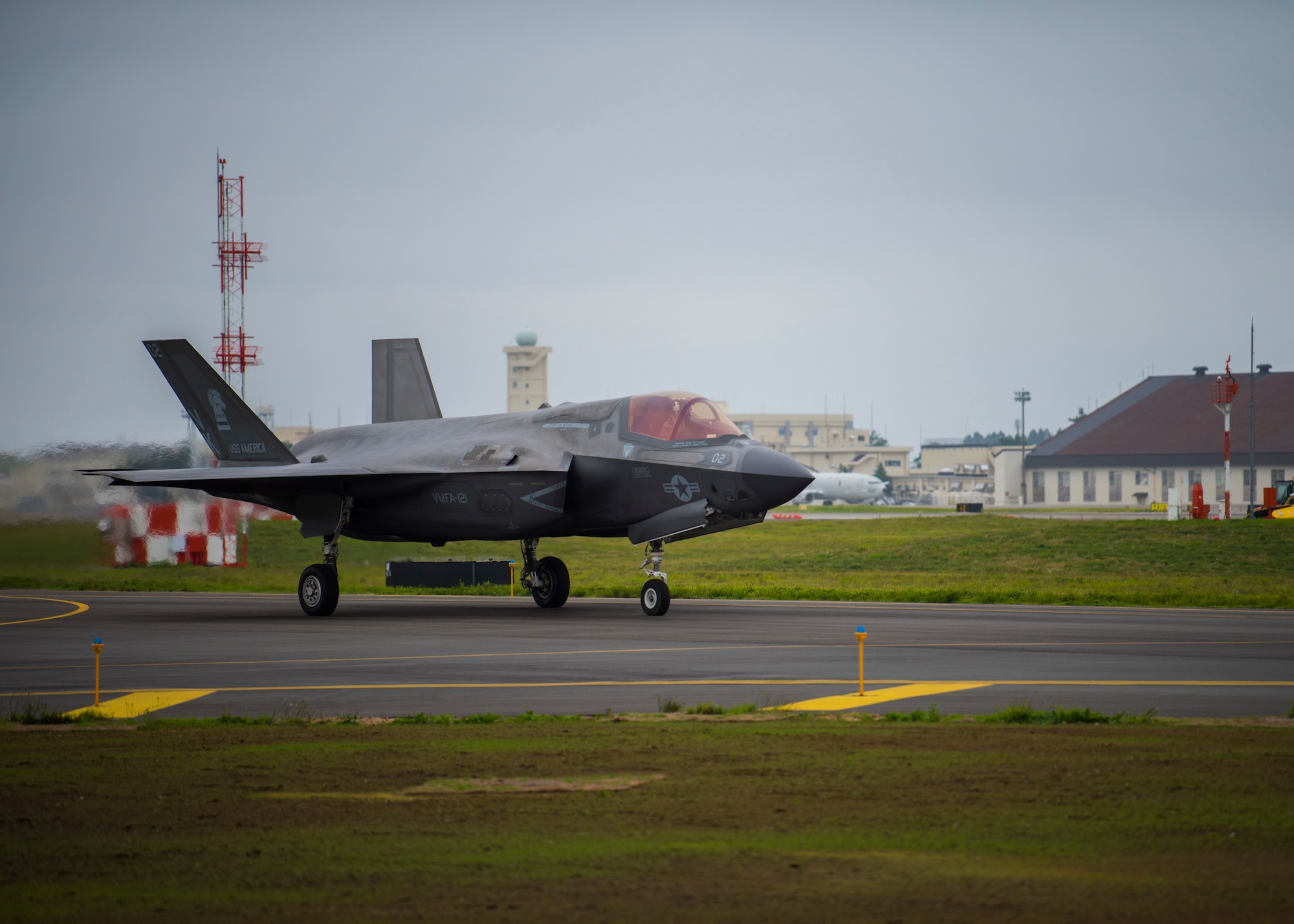 An F-35 taxis from the left.