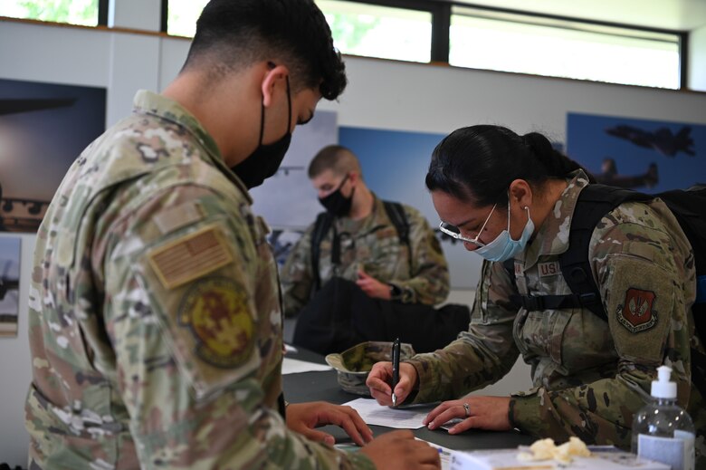 A U.S. Air Force Airman from the 48th Medical Group out processes before deployment Aug. 23, 2021, at Royal Air Force Mildenhall, England. Airmen from the 100th Logistics Readiness Squadron, and 100th Force Support Squadron came together to assist in the quick deployment of Airmen from 100th Security Forces Squadron and the 48th MDG in support of Operation Allies Refuge.
