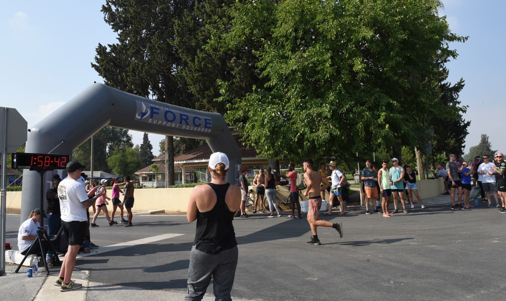 Triathlon spectators clapping as runners pass a finish line