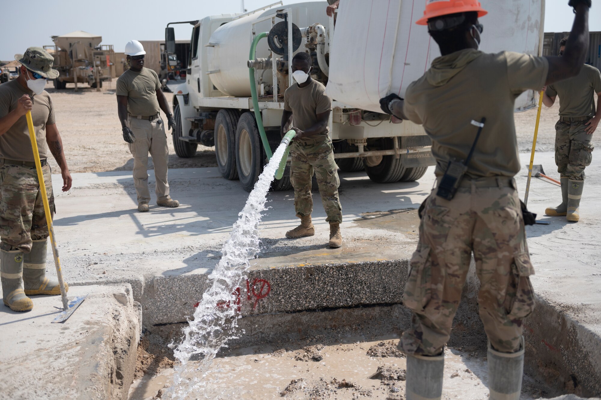 Airmen with the 332nd Expeditionary Civil Engineer Squadron repair concrete during an exercise Aug. 27, 2021, in an undisclosed location somewhere in Southwest Asia. The exercise tested how quickly 332nd ECES Airmen could restore potential damage to the airfield. (U.S. Air Force photo by Senior Airman Cameron Otte)
