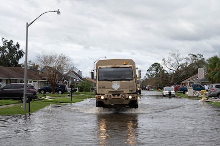 Louisiana National Guard members in high-water vehicles and boats work with St. John the Baptist Parish officials to rescue people stranded in their homes in the wake of Hurricane Ida.