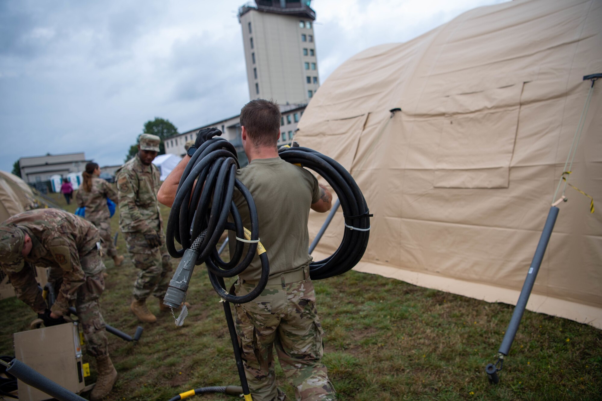 Airman carries cords.