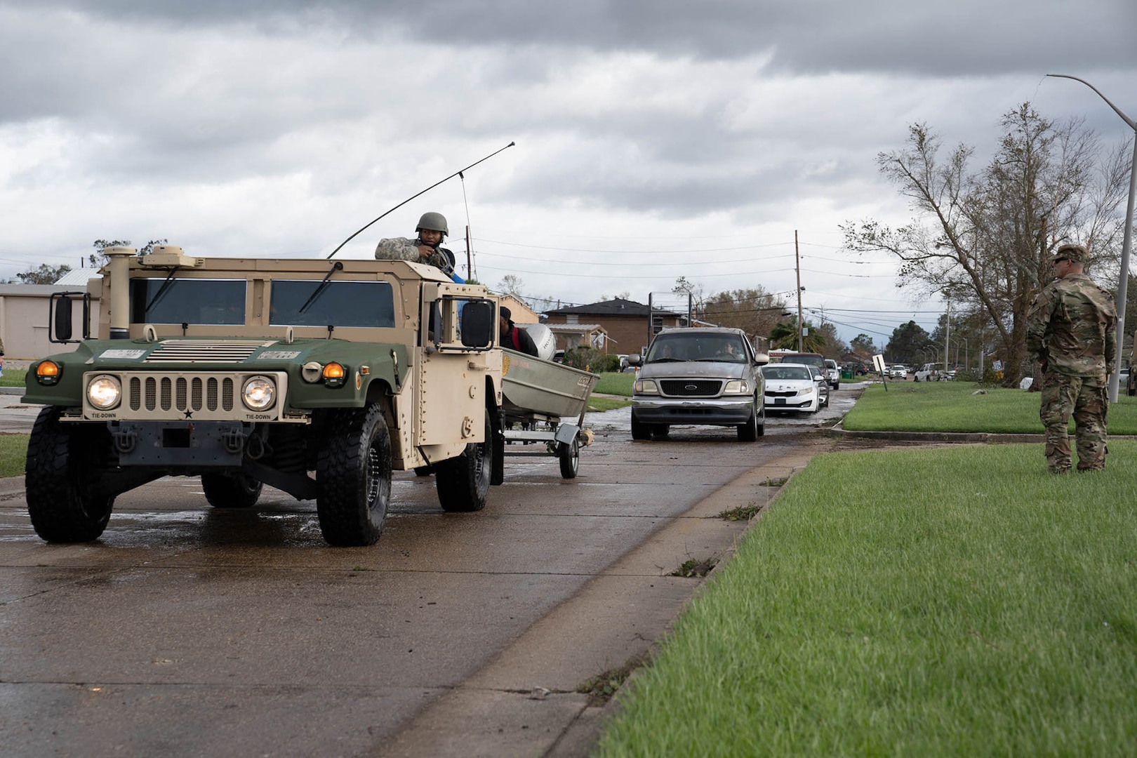 Louisiana National Guard members in high-water vehicles and boats work with St. John the Baptist Parish officials to rescue people stranded in their homes in the wake of Hurricane Ida.