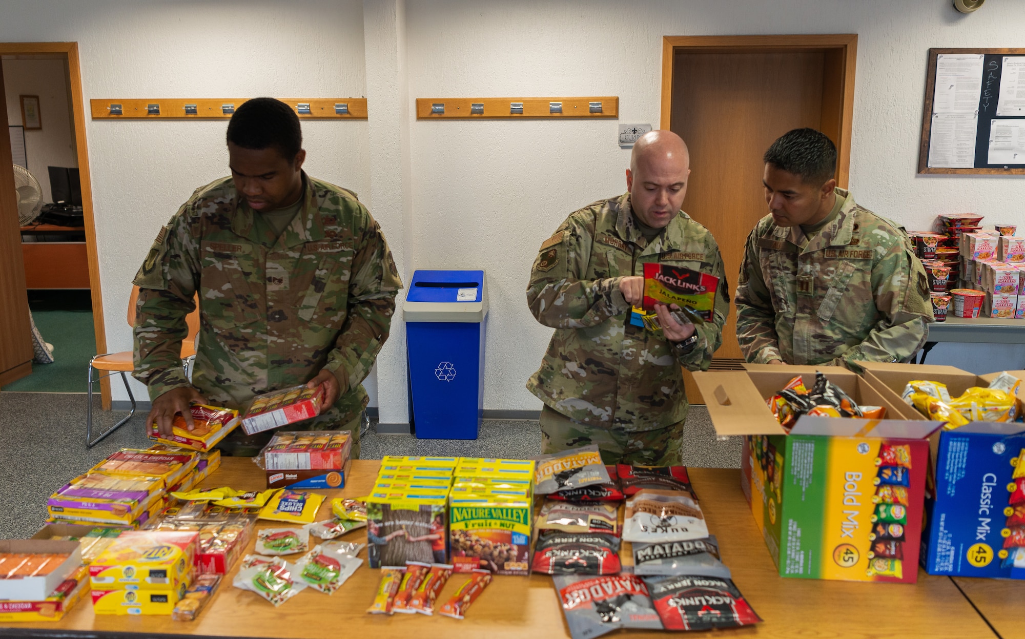 Airman sort through snacks.
