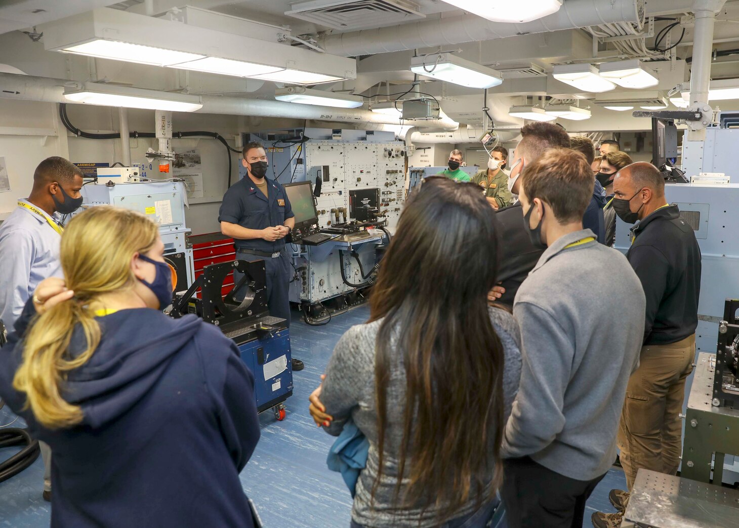 Aviation Electronics Technician 1st Class Allan Kerns, from San Diego, briefs Rep. Jimmy Panetta and congressional staffers during a tour of the aircraft intermediate maintenance department aboard the aircraft carrier USS Abraham Lincoln (CVN 72).