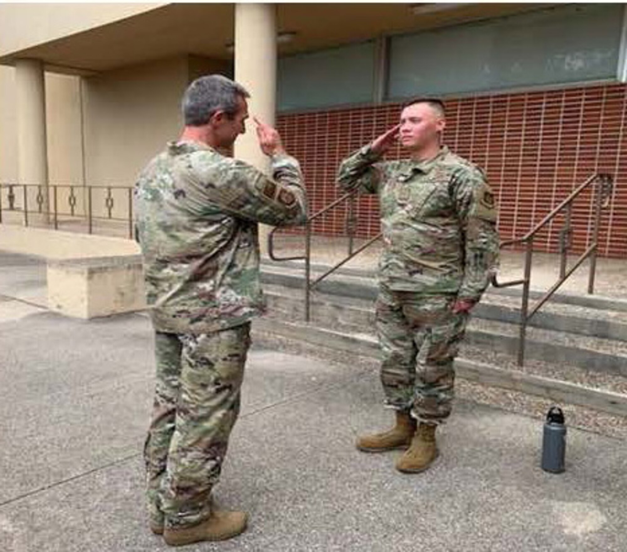 Senior Airman Alexander Byrd, a 23rd Intelligence Squadron  analyst currently on Military Personnel Appropriation (MPA) orders with the 390th Cyberspace Operations Squadron, salutes10th Air Force Commander Maj. Gen. Bryan Radliff after being coined in July. Byrd provided the general an operational highlight briefing demonstrating how Air Reserve Component  Airmen impact mission and seamlessly work alongside the Regular Air Force.