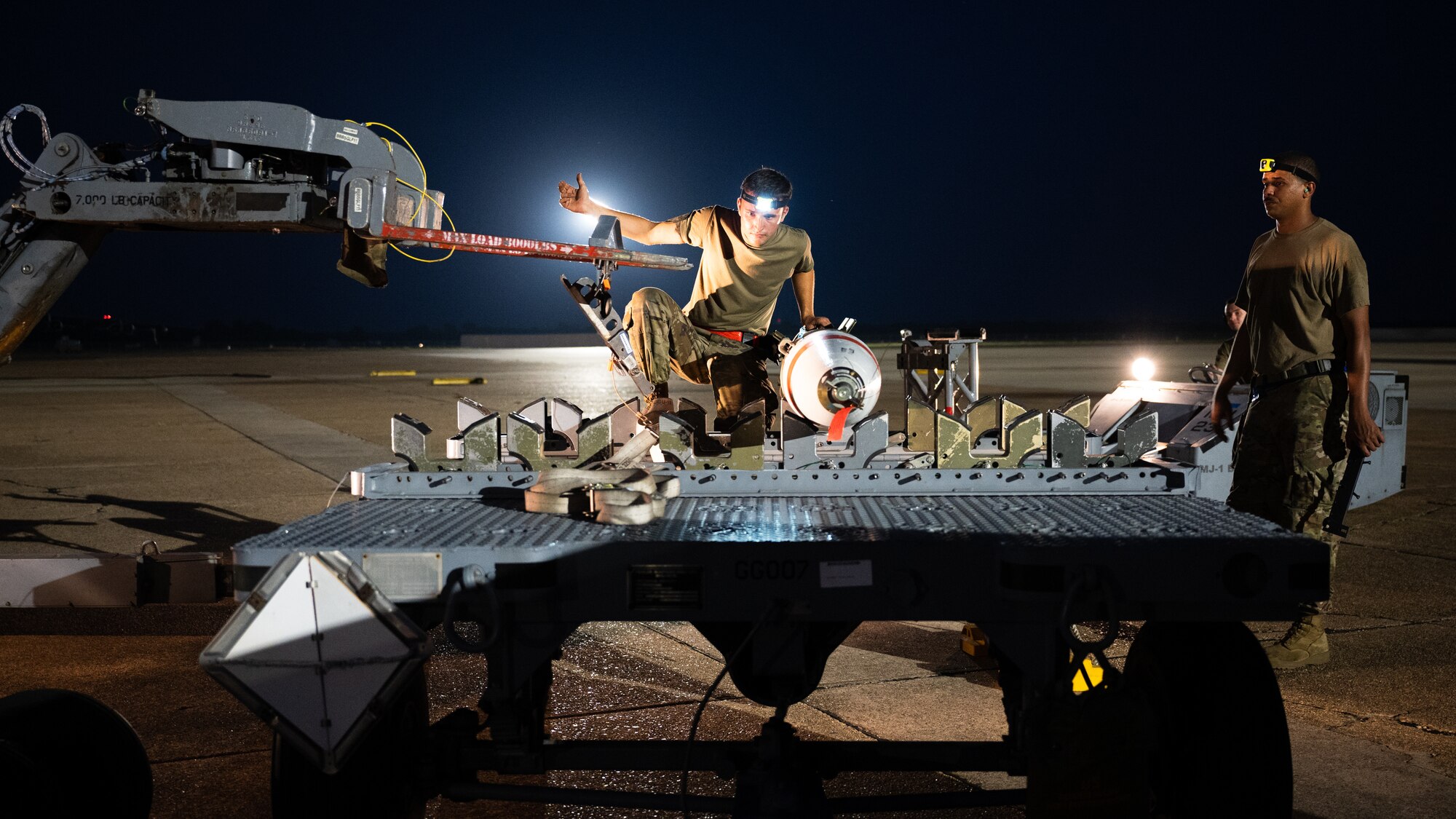 A weapons load crew team from the 2nd Aircraft Maintenance Squadron transfer an Mk-62 Quickstrike naval mine in support of a training exercise at Barksdale Air Force Base, Louisiana, Aug. 25, 2021. The 2nd AMXS weapons load crews have the ability to load naval mines, as well conventional and nuclear weapons. (U.S. Air Force photo by Senior Airman Jacob B. Wrightsman)