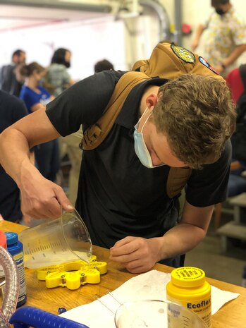 SEAP Intern Ian Clark pours silicone mix in a SeaJelly mold while on tour at Carderock in West Bethesda, Md., on Aug. 4, 2021.