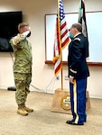 Staff Sgt. Cameron Reeves (left) renders the first salute to newly commissioned U.S. Army Reservist, Maj. Peter Edelstein, medical doctor and general surgeon, during a ceremony at Bayne-Jones Army Community Hospital Aug. 27.