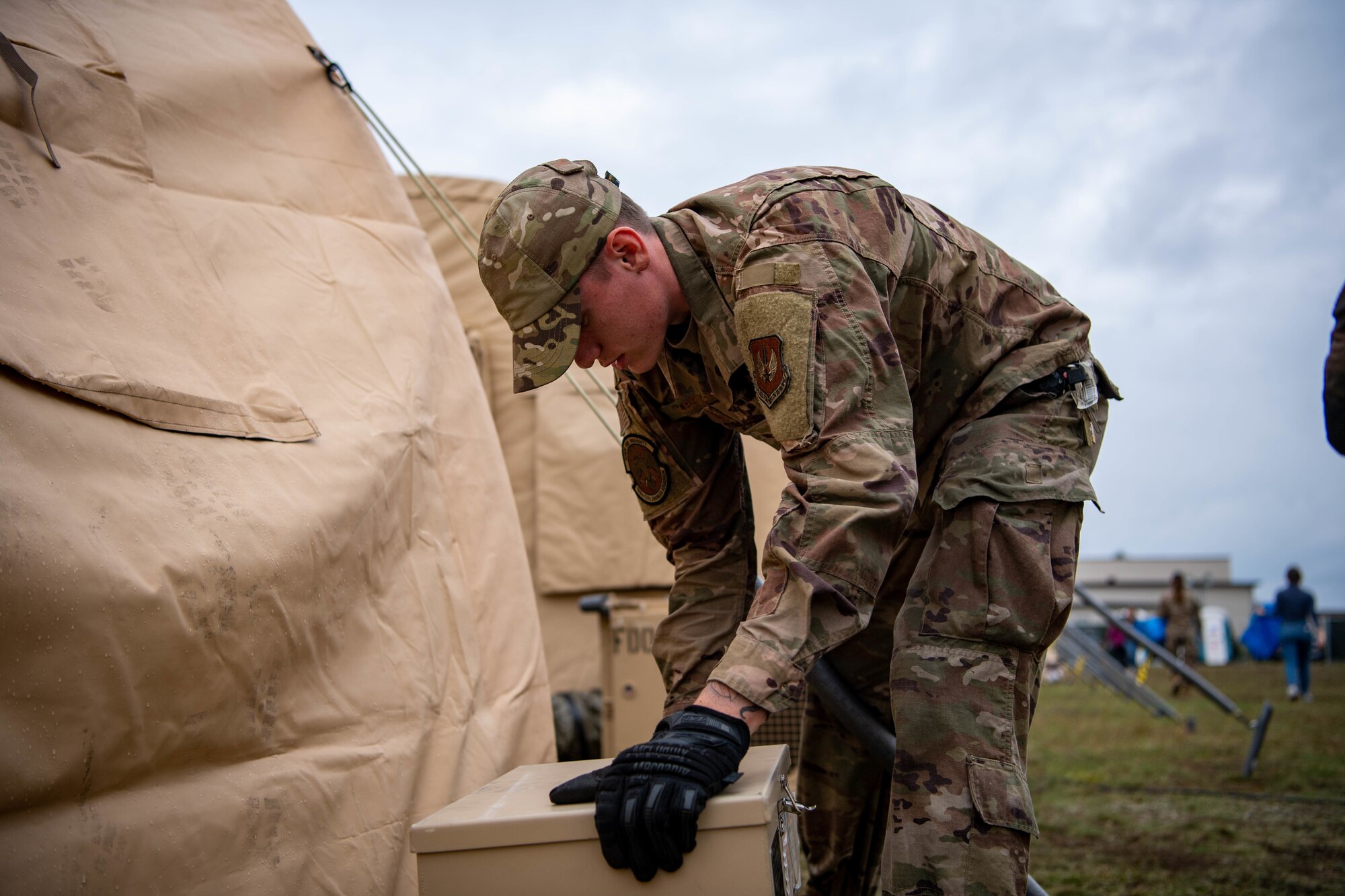 Airman installs electricity to pod.