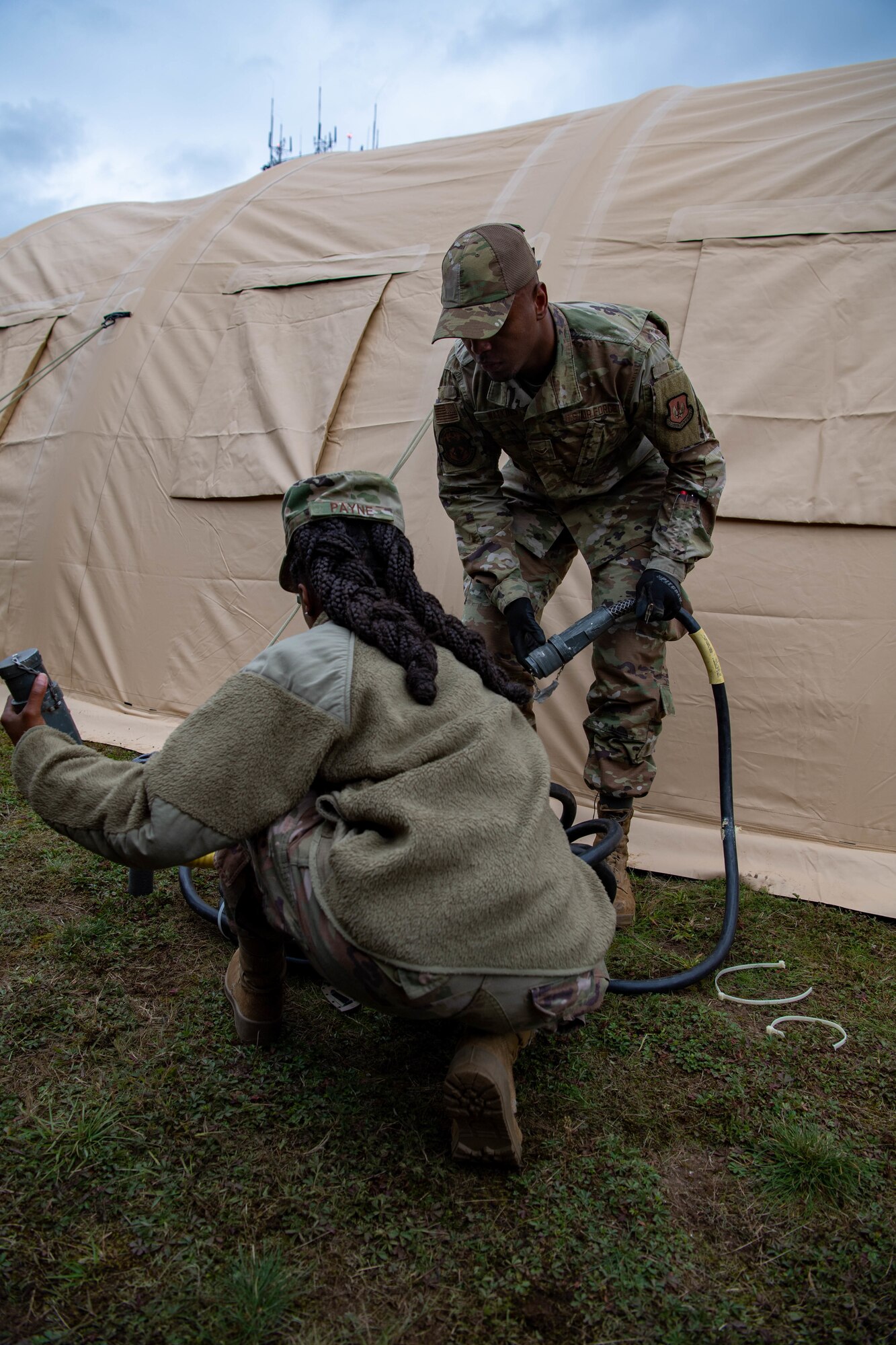 Airmen install electricity for pods.