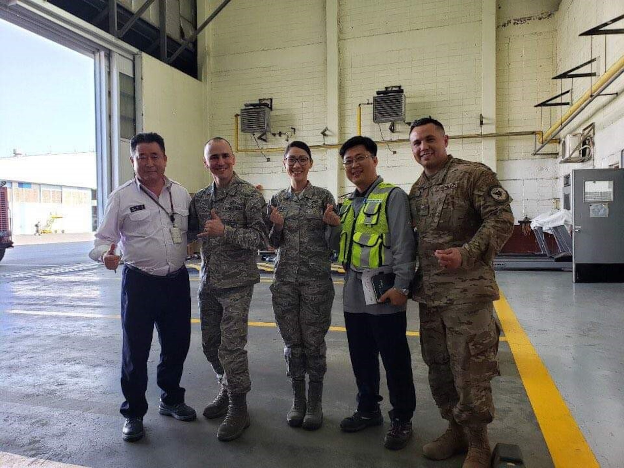 U.S. Air Force Staff Sgt. Angela Martinez, the 354th Civil Engineering Squadron (CES) noncommissioned in charge of material control, members from the Korean Airline and Airmen assigned to the 354th CES pose for a group photo on Gimhae Air Base, South Korea, April 2019.