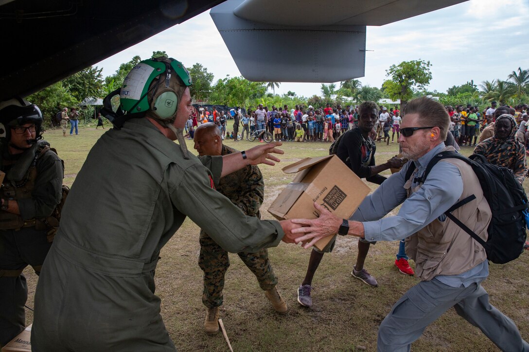 United States Marines with Marine Medium Tiltrotor Squadron 266, 2nd Marine Aircraft Wing, II Marine Expeditionary Force, deliver cases of food using an MV-22B Osprey in support of Joint Task Force-Haiti for a humanitarian assistance and disaster relief mission near Port-au-Prince, Haiti, Aug. 27, 2021. (U.S. Marine Corps photo by Lance Cpl. Caleb Stelter)