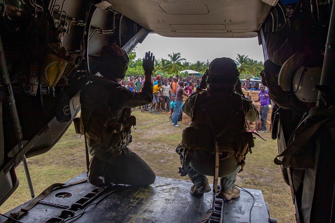 United States Marines with Marine Medium Tiltrotor Squadron 266, 2nd Marine Aircraft Wing, II Marine Expeditionary Force, prepare for takeoff in an MV-22B Osprey after delivering cases of food in support of Joint Task Force-Haiti for a humanitarian assistance and disaster relief mission in Les Anglais, Haiti, Aug. 27, 2021. (U.S. Marine Corps photo by Cpl. Yuritzy Gomez)