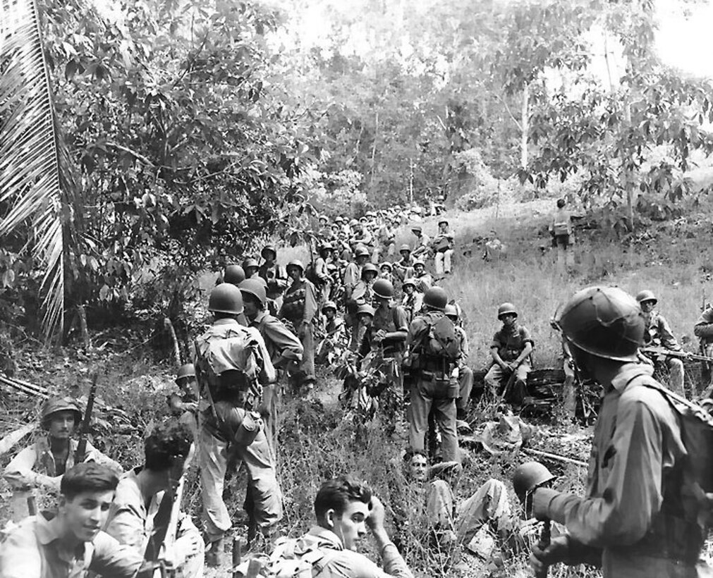 Marines rest in a jungle area.