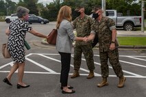 U.S. Marine Corps Col. Curtis V. Ebitz, center, the commanding officer of Marine Corps Air Station New River and Sgt. Maj.  Douglas W. Gerhardt, right the sergeant major of MCAS New River welcome Kelsey Byerly, the military legislative assistant for Sen. Richard Burr of North Carolina and staff to the headquarters of MCAS New River, North Carolina, Aug. 25, 2021.