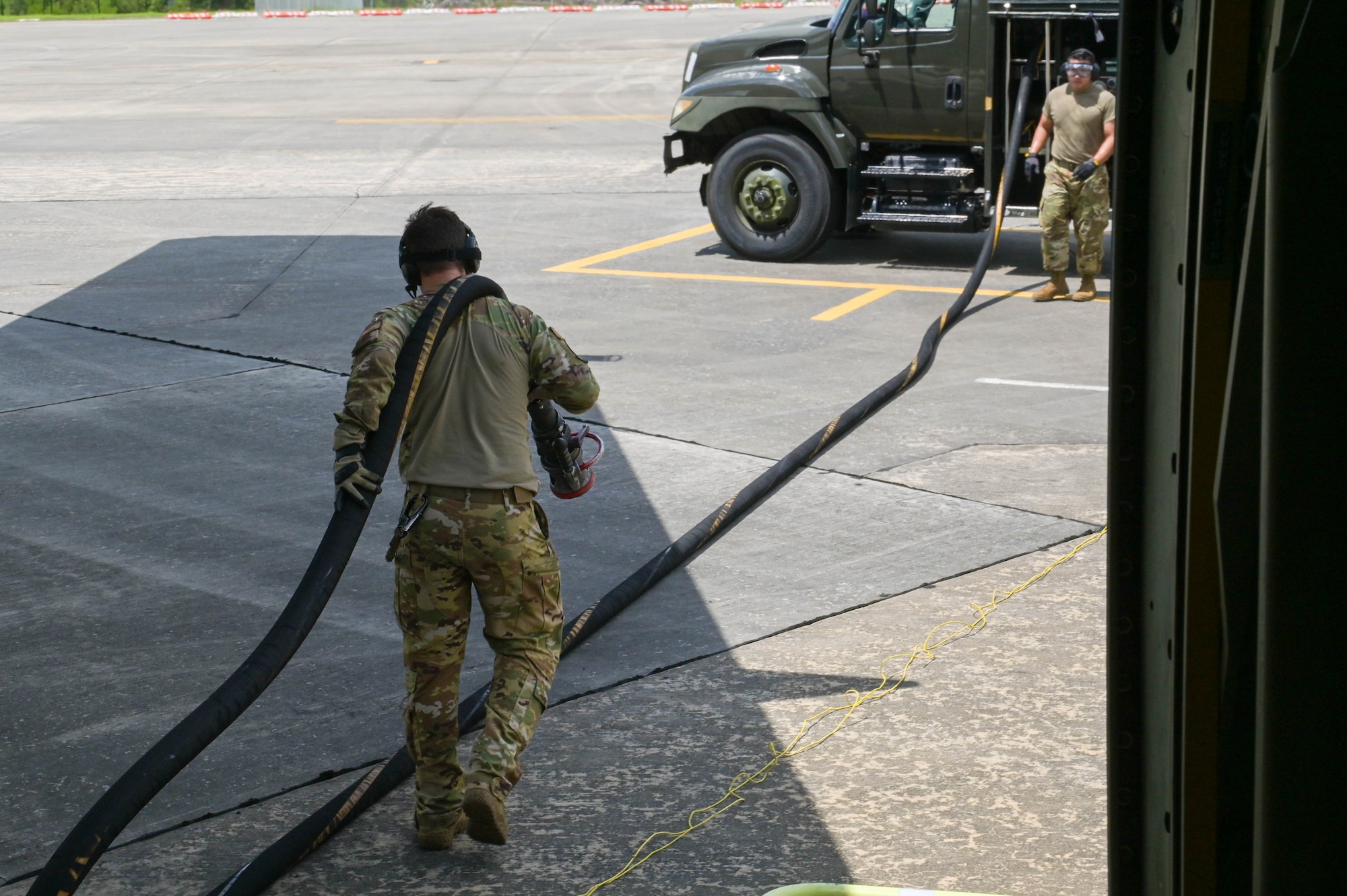 U.S. Air Force Senior Airman John Wheeler, 71st Rescue Squadron loadmaster, completes a hot pit refuel of an HC-130J Combat King II aircraft at Moody Air Force Base, Georgia, Aug. 24, 2021. Hot pit refueling occurs while aircraft engines are running, cutting down on ground time and allowing pilots to quickly return to aerial operations. The 71st RQS conducted an air-to-air refuel with a KC-46A Pegasus assigned to the 916th Air Refueling Wing, Seymour Johnson Air Force Base, North Carolina as the first operational unit to be refueled by the KC-46A Pegasus. (U.S. Air Force photo by Senior Airman Rebeckah Medeiros)
