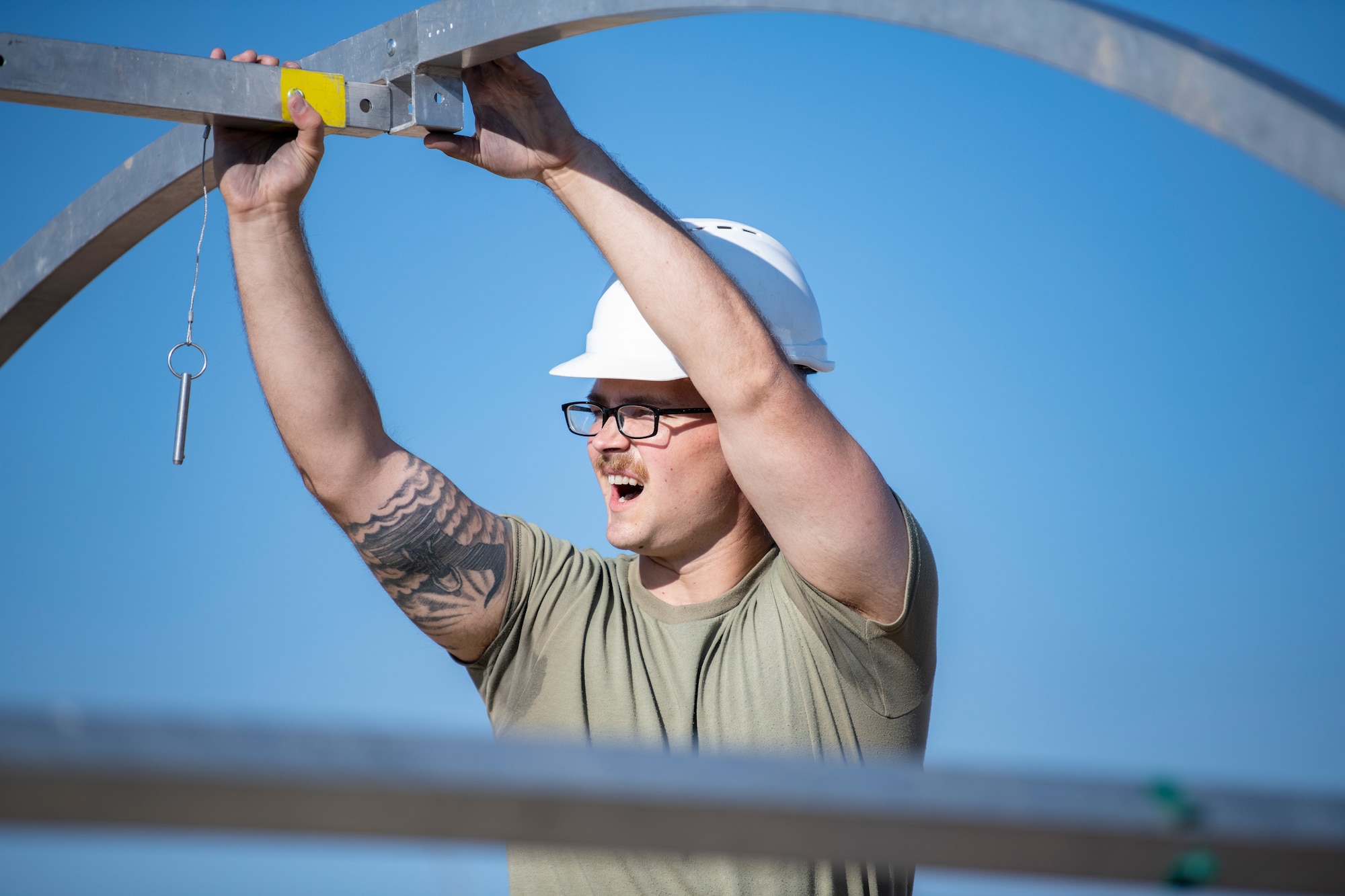 Airman sets up metal bars.
