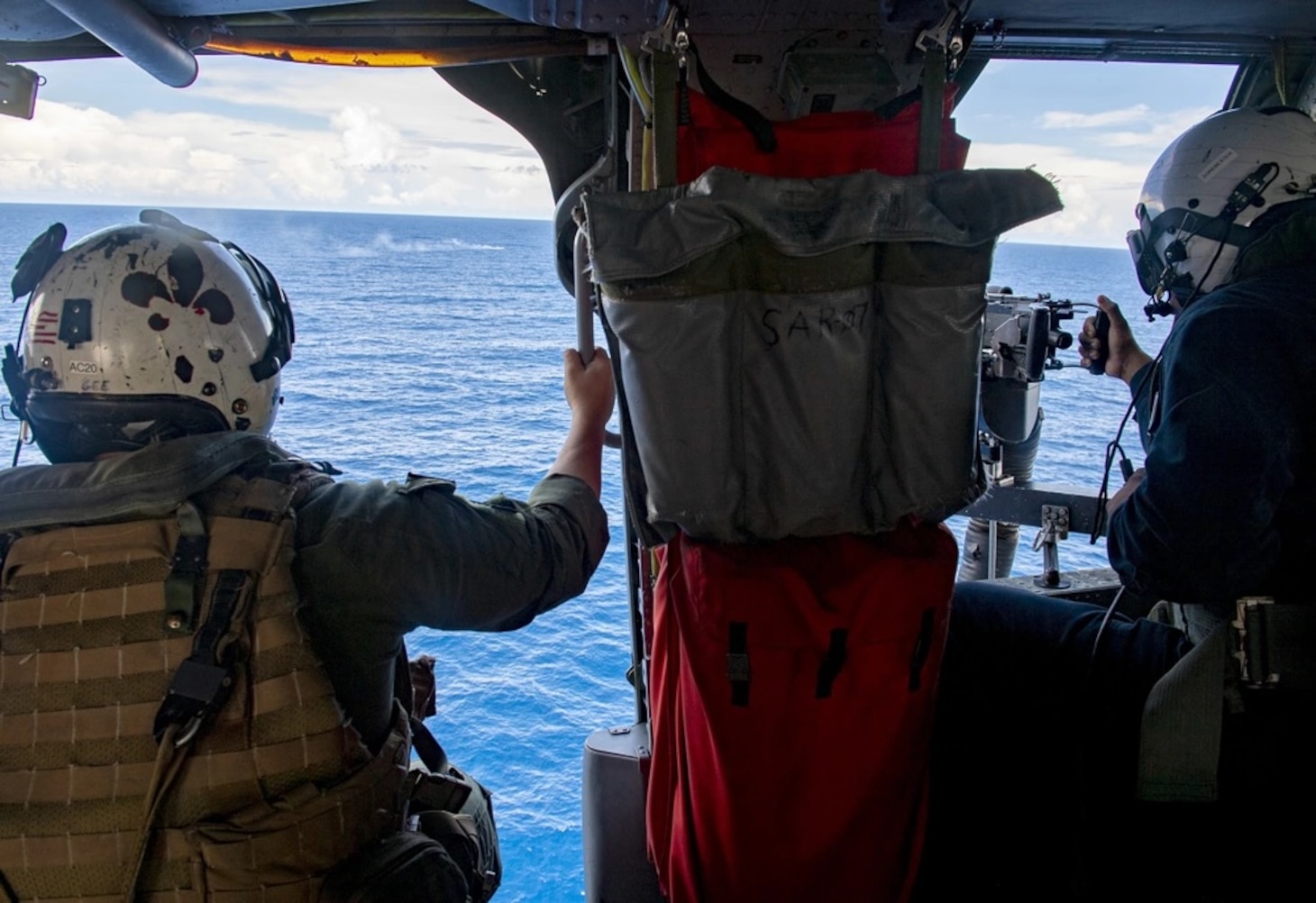 Naval Aircrewmen (Helicopter) 1st Class Ryan Gee and Mineman Seaman Jonathan Alonsojuarez participate in a gunnery exercise inside of a MH-60S Seahwak helicopter assigned to the “Blackjacks” of Helicopter Sea Combat Squadron (HSC) 21 aboard the Independence-variant littoral combat ship USS Tulsa (LCS 16), Aug. 31, 2021.