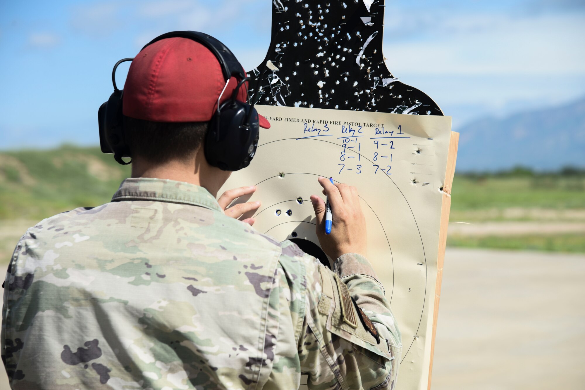 A photo of an Airman inspecting a shooting target.