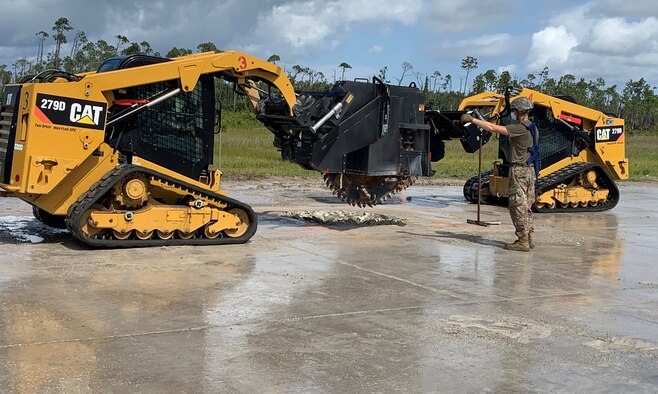 Airmen guides wheel saw on Tyndall AFB runway.