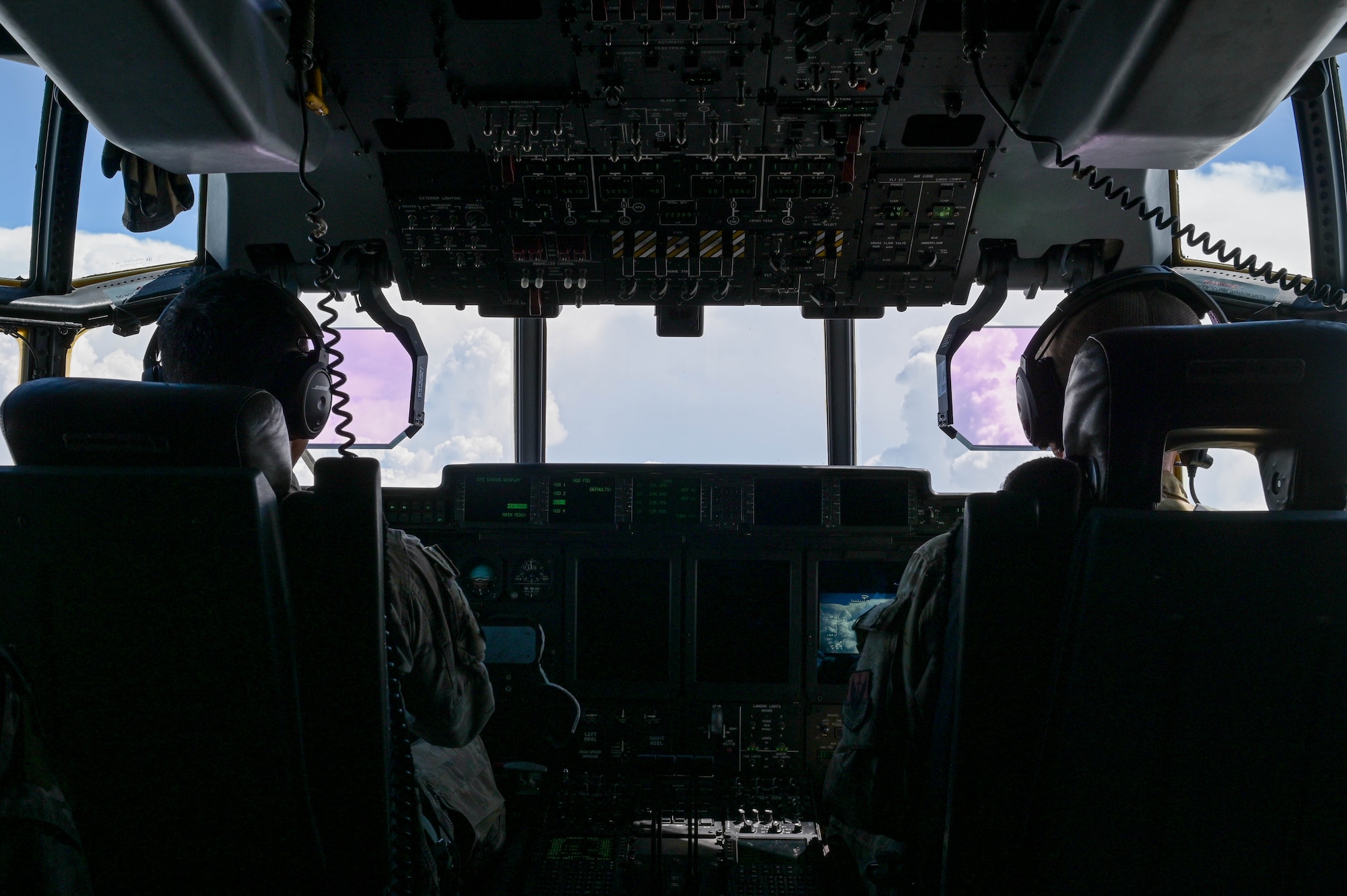 U.S. Air Force Lt. Col. Phillip Varelik, left, and Maj. Patrick Robinson, 71st Rescue Squadron HC-130J Combat King II pilots, fly out of Moody Air Force Base, Georgia, Aug. 24, 2021. The aerial refueling capabilities of the HC-130J increases the combat range of rescue forces, supporting prolonged missions. The 71st RQS conducted an air-to-air refuel with a KC-46A Pegasus assigned to the 916th Air Refueling Wing, Seymour Johnson Air Force Base, North Carolina as the first operational unit to be refueled by the KC-46A Pegasus. (U.S. Air Force photo by Senior Airman Rebeckah Medeiros)