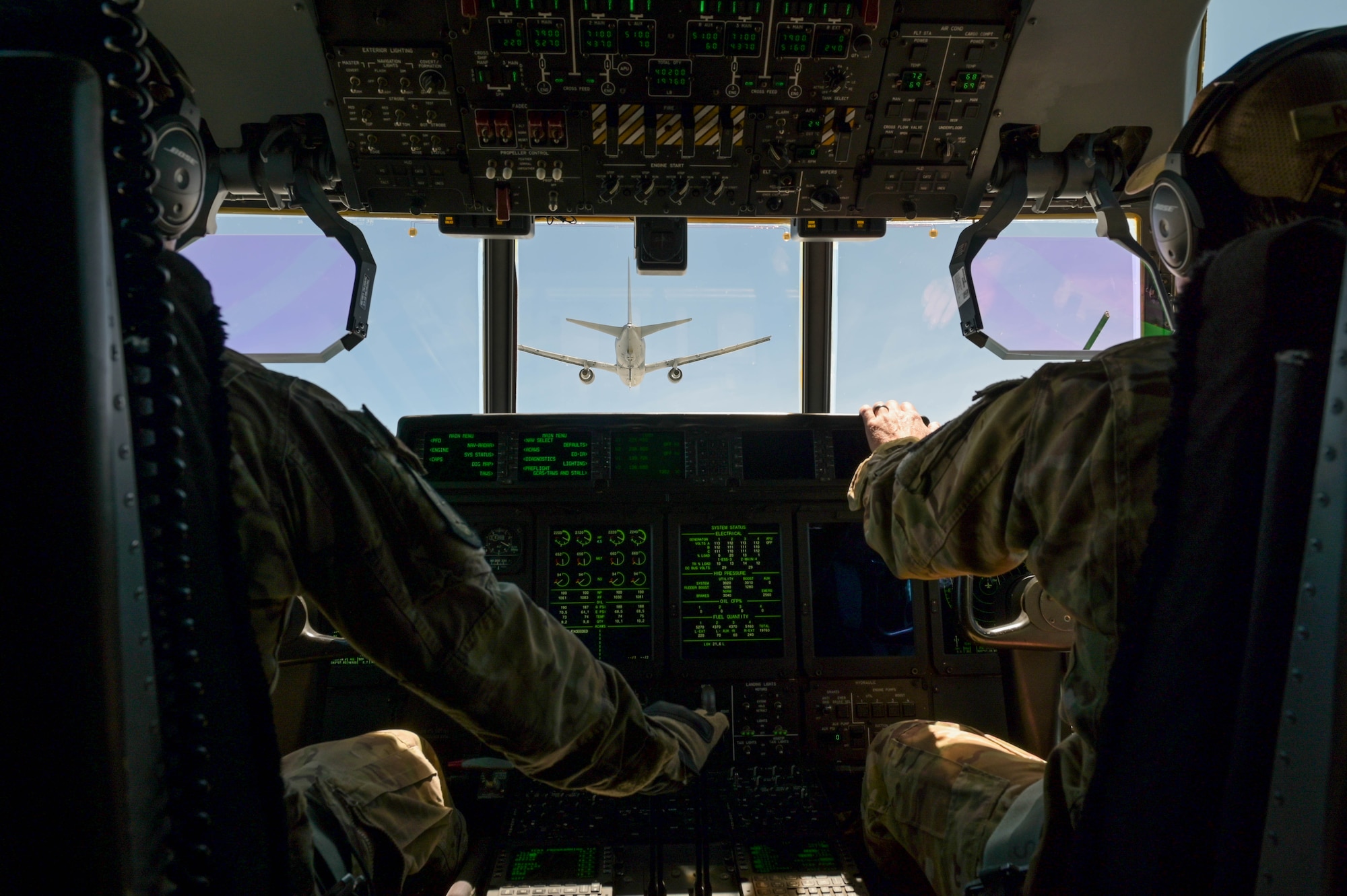 U.S. Air Force Lt. Col. Philip Varilek, left, and Maj. Patrick Robinson, 71st Rescue Squadron HC-130J Combat King II pilots, prepare to receive fuel from a KC-46A Pegasus assigned to the 916th Air Refueling Wing, Seymour Johnson Air Force Base, North Carolina, during a flight near Moody Air Force Base, Georgia, Aug. 24, 2021. The KC-46A’s hose and drogue system adds additional mission capability that is independently operable from the refueling boom system. The 71st RQS is the first operational unit to be refueled by the KC-46A Pegasus. (U.S. Air Force photo by Senior Airman Rebeckah Medeiros)