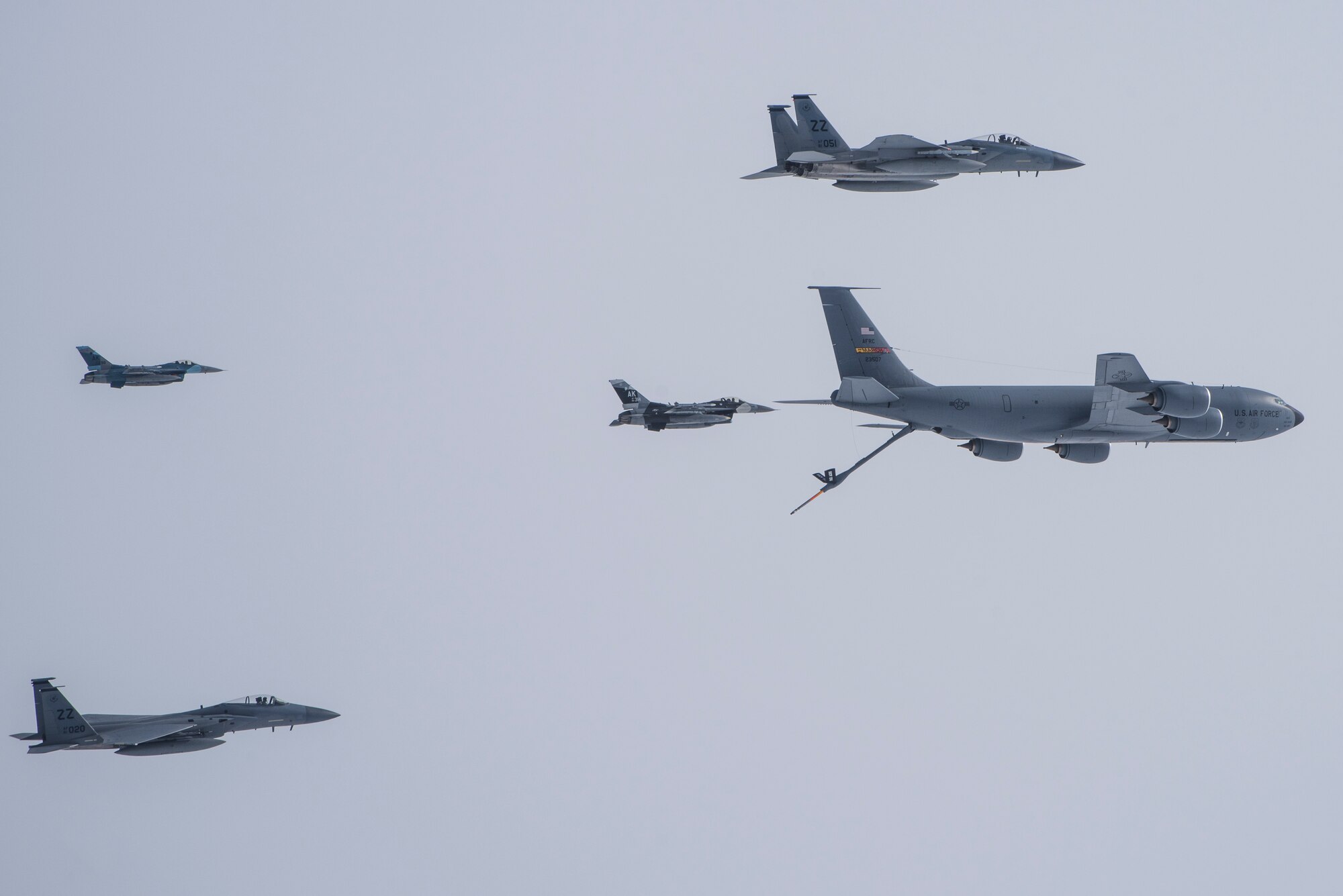 U.S. Air Force F-15C Eagles assigned to the 44th Fighter Squadron, Kadena Air Base, Japan, F-16 Fighting Falcons assigned to the 18th Aggressor Squadron, and a KC-135 Stratotanker assigned to the 912th Air Refueling Squadron, March Air Reserve Base, Calif., fly in close proximity during Red Flag-Alaska 21-3, near Eielson Air Force Base, Alaska, Aug. 23, 2021. The exercise gives aviators an opportunity to hone the skills required in combat by providing training scenarios that replicate near-peer adversary tactics, techniques and procedures in a controlled environment. (U.S. Air Force photo by Senior Airman Aaron Larue Guerrisky)