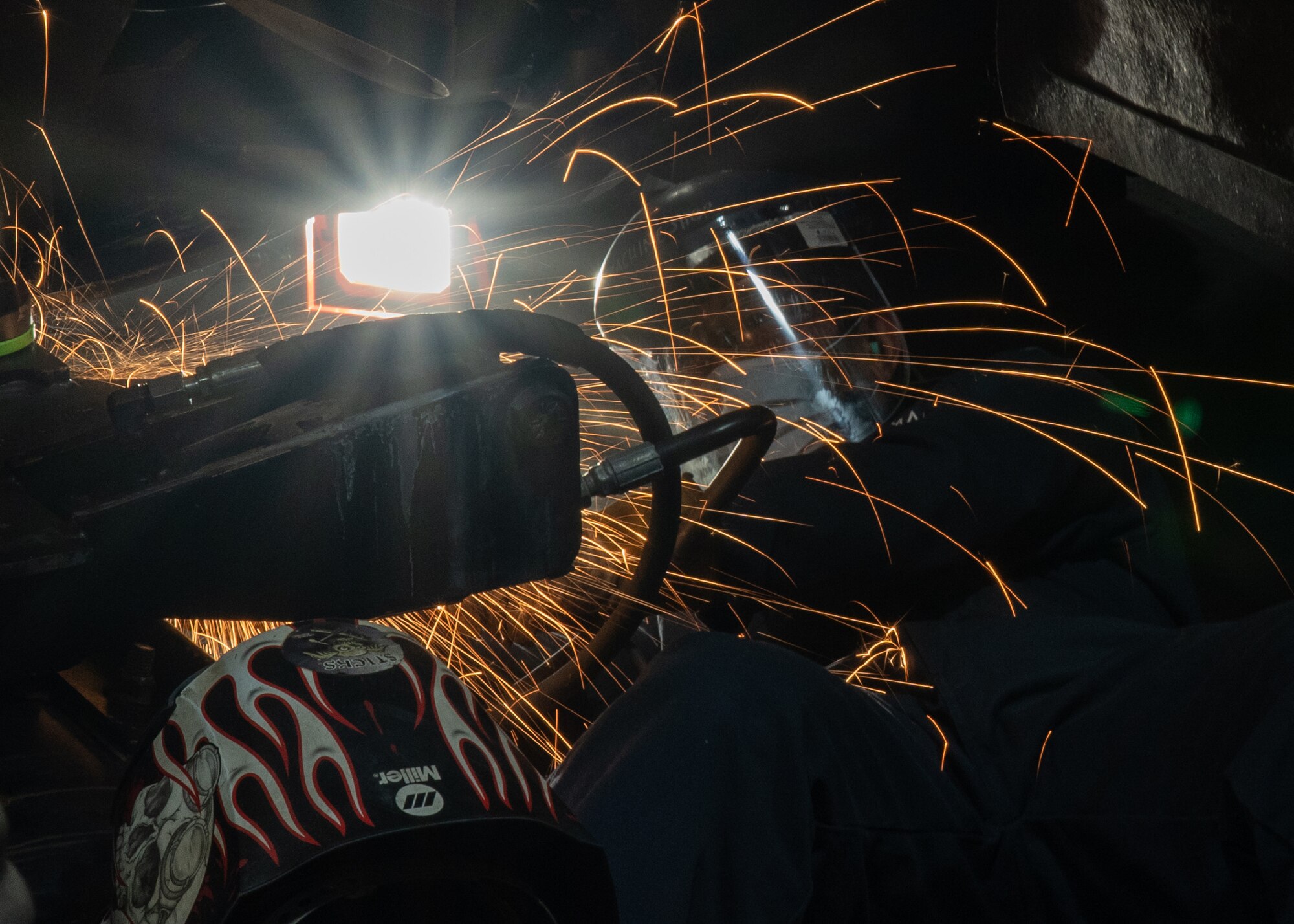 Person welds on a machine