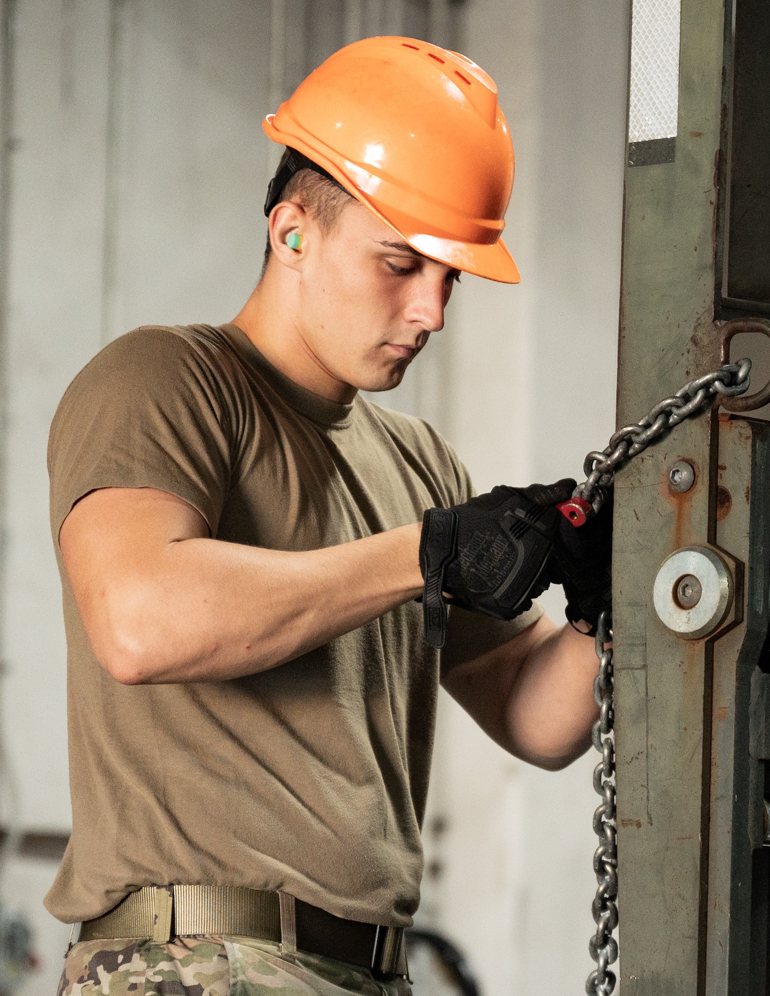 Airman 1st Class Erik Hite, 2nd Munitions Squadron conventional maintenance technician, secures a chain to a forklift at Barksdale Air Force Base, Louisiana, Aug. 24, 2021.