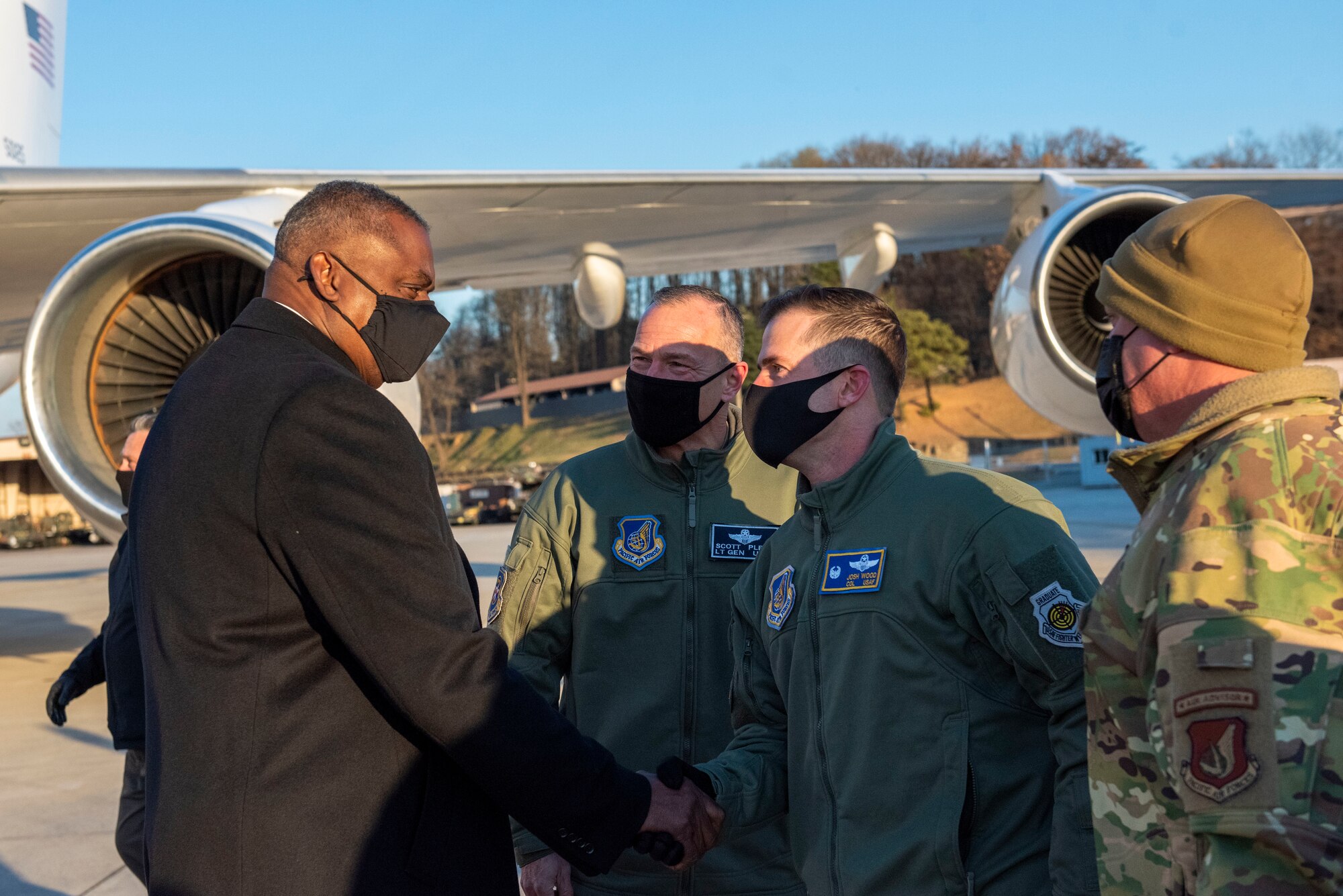 Lloyd J. Austin III, United States Secretary of Defense, left, is greeted by Col. Joshua Wood, 51st Fighter Wing commander, at Osan Air Base