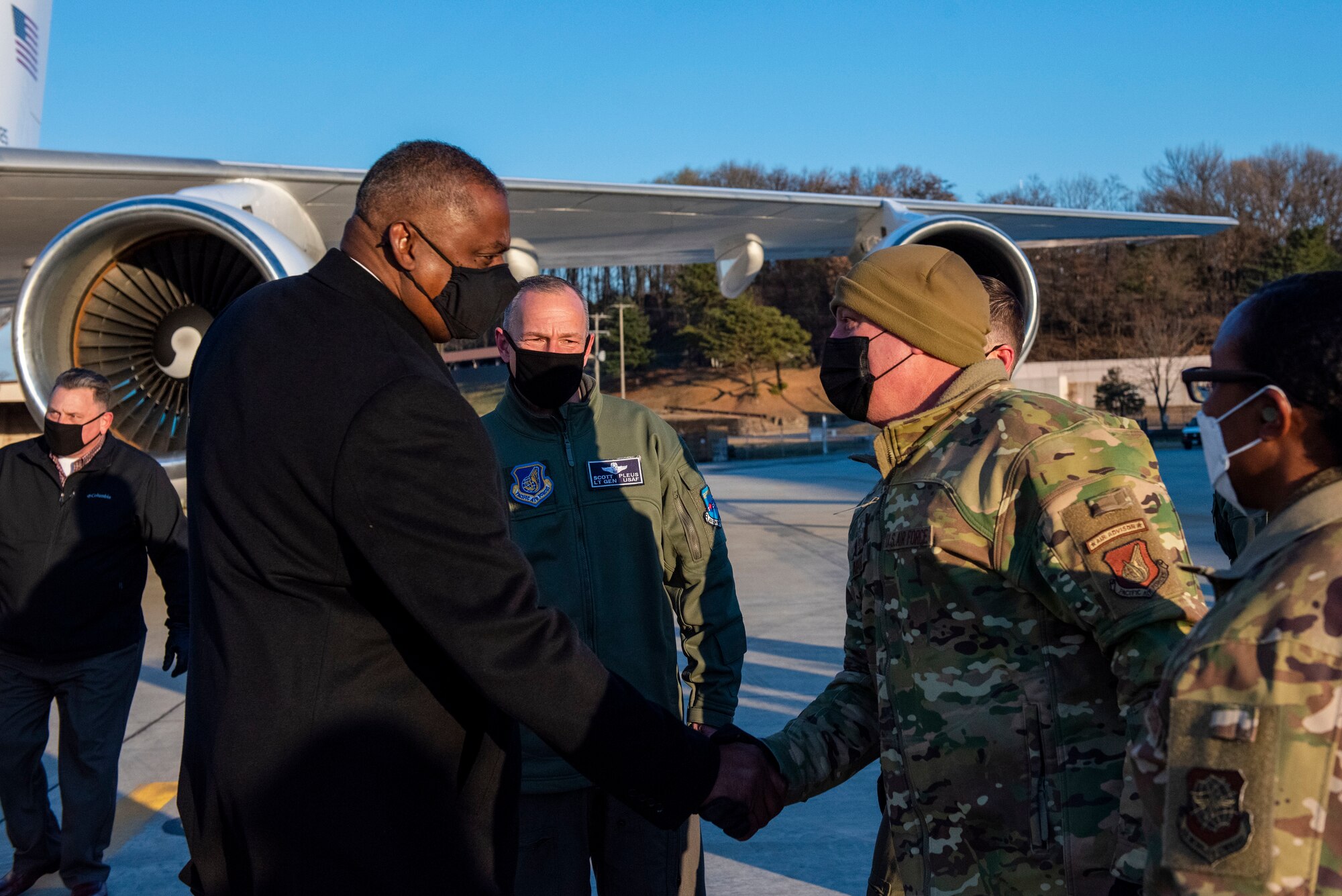 Lloyd J. Austin III, United States Secretary of Defense, left, is greeted by Chief Master Sgt. Justin Apticar, 51st Fighter Wing command chief, at Osan Air Base