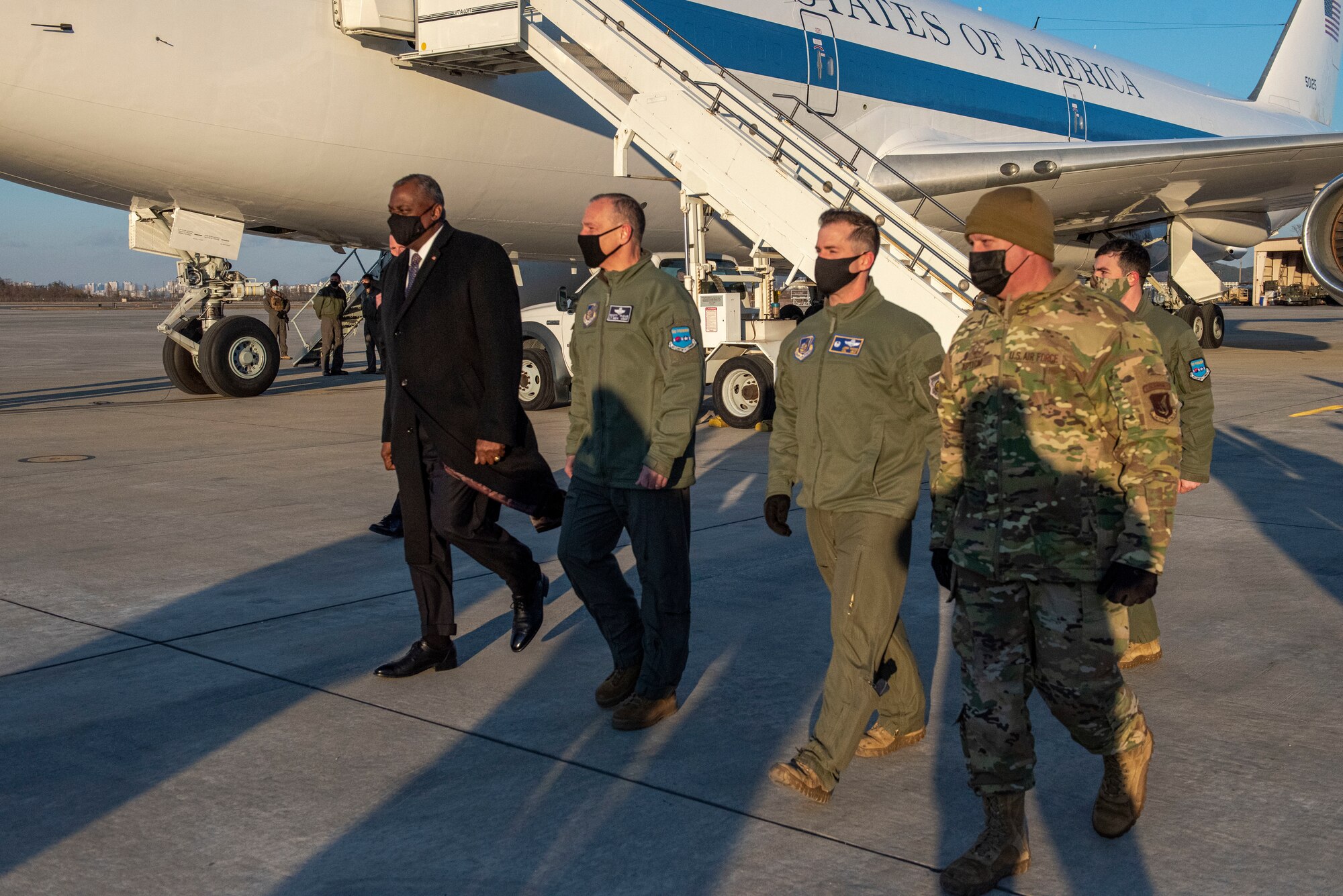 Lloyd J. Austin III, United States Secretary of Defense, left, is escorted across the flight line