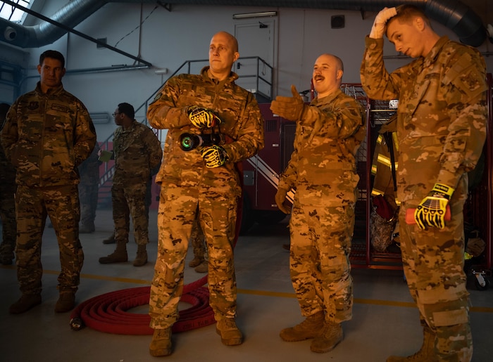 U.S. Air Force Brig. Gen. Josh Olson, second from left, 86th Airlift Wing commander, puts the fire out for a mobile digital fire trainer at Chievres Air Base, Belgium, Nov. 16, 2021. During a 424 Air Base Squadron immersion tour, Chievres welcomed Olson and provided him with an up-close look at the day to day operations. It is the mission of fire protection Airmen to ensure the safety of others and to assist civilian fire departments when needed. (U.S. Air Force photo by Airman Jared Lovett)
