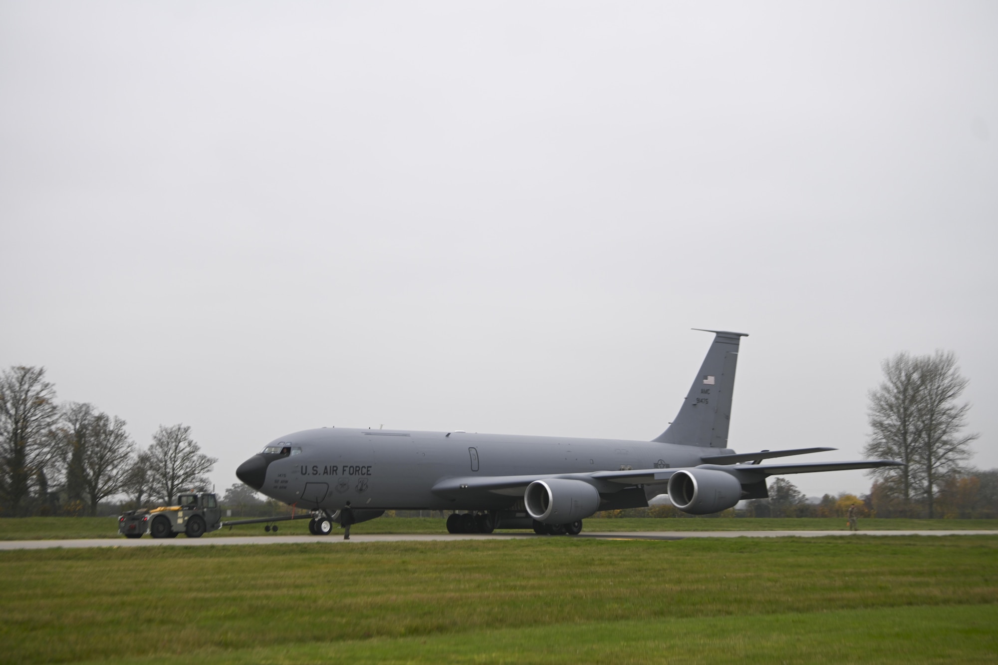 U.S. Airmen assigned to the 100th Air Refueling Wing move a Block 45 variant of a KC-135 Stratotanker aircraft along the flightline at Royal Air Force Mildenhall, England, Nov. 24, 2021. The Block 45 variant of KC-135 is equipped with advanced autopilot and glass display instrument features. (U.S. Air Force photo by Senior Airman Joseph Barron)